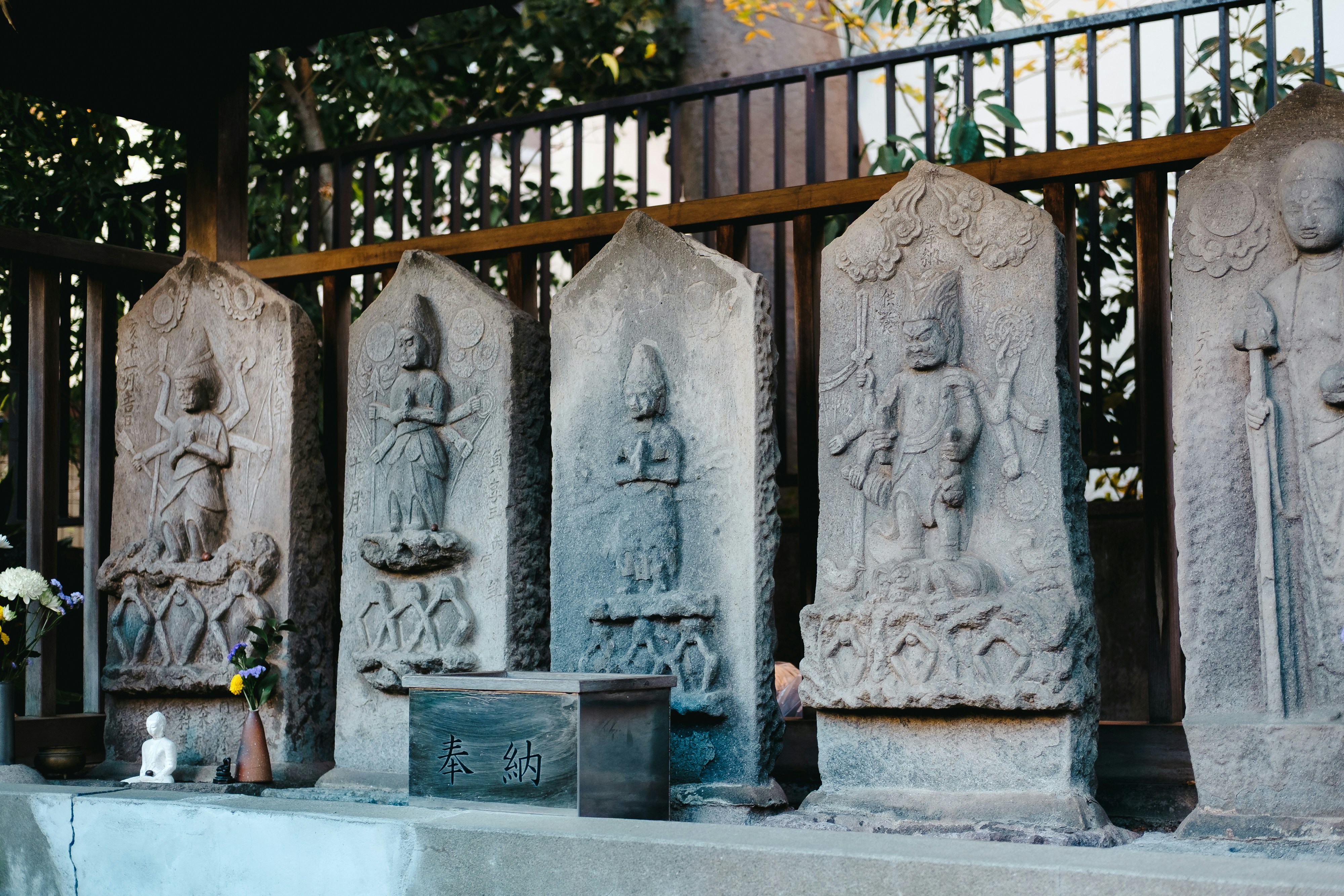 Stone statues of buddhist figures in a row