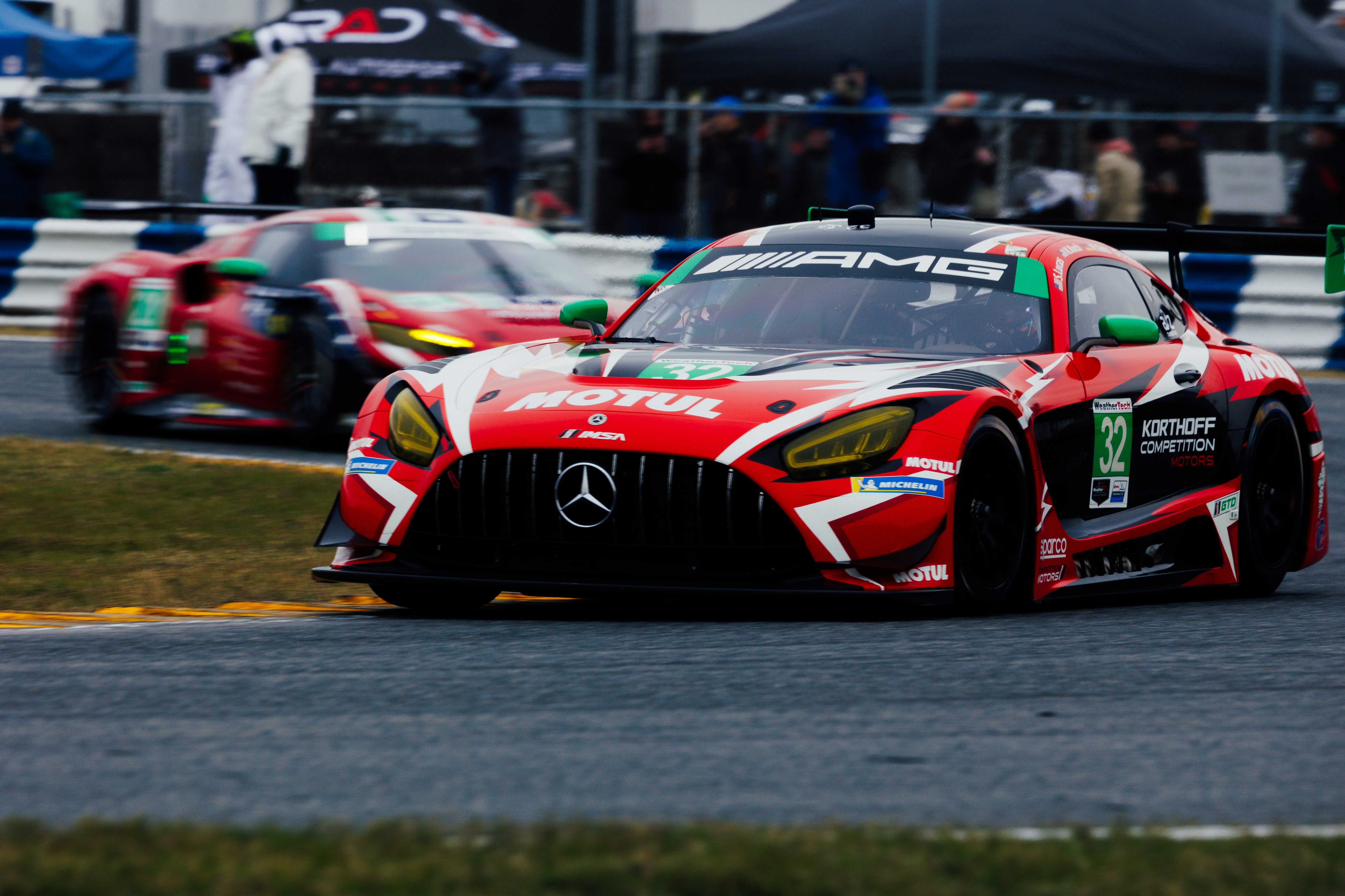 Two race cars speeding on a track