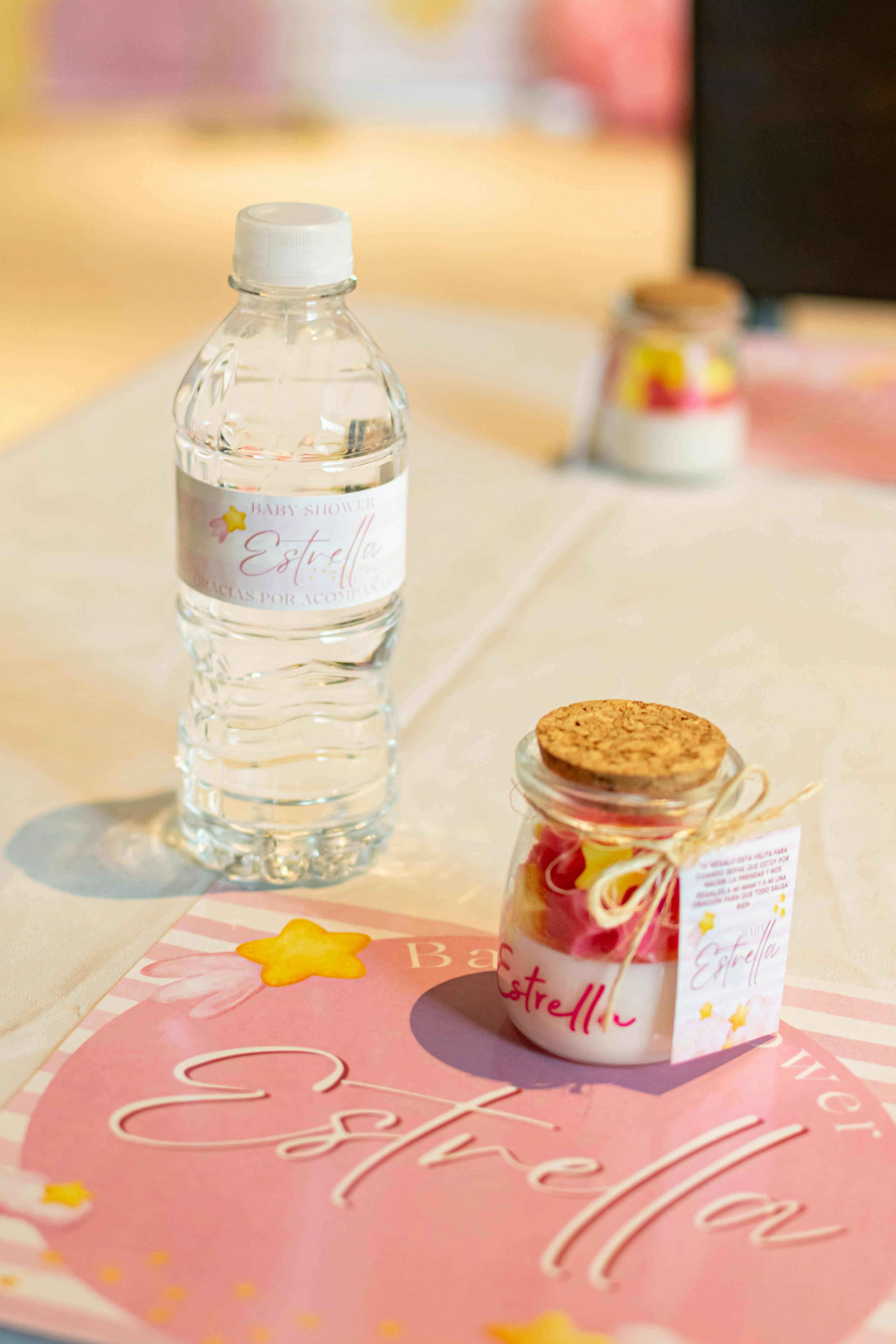 Baby shower favors with water bottle and candle.