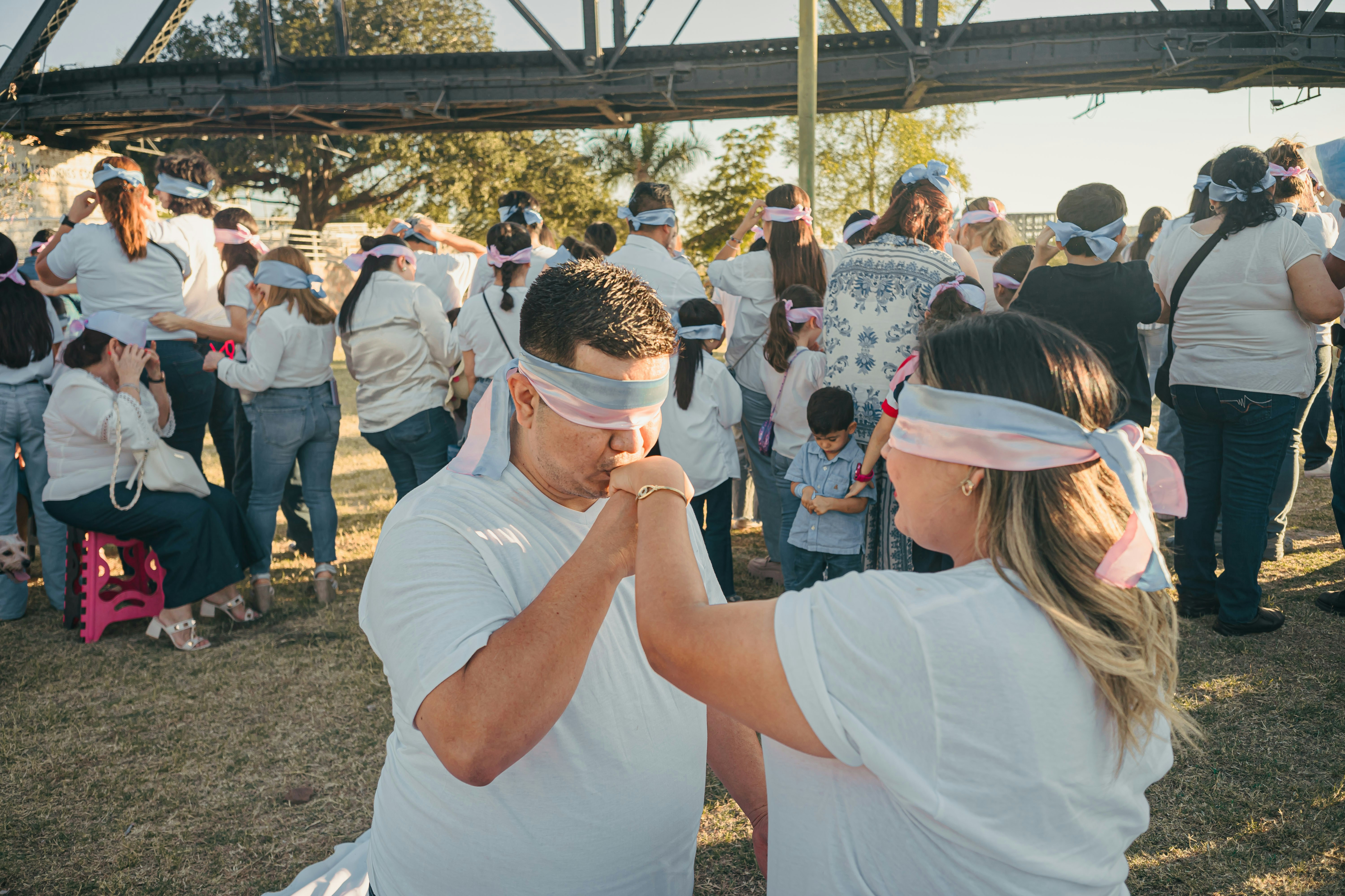 Couple blindfolded playing a game outdoors