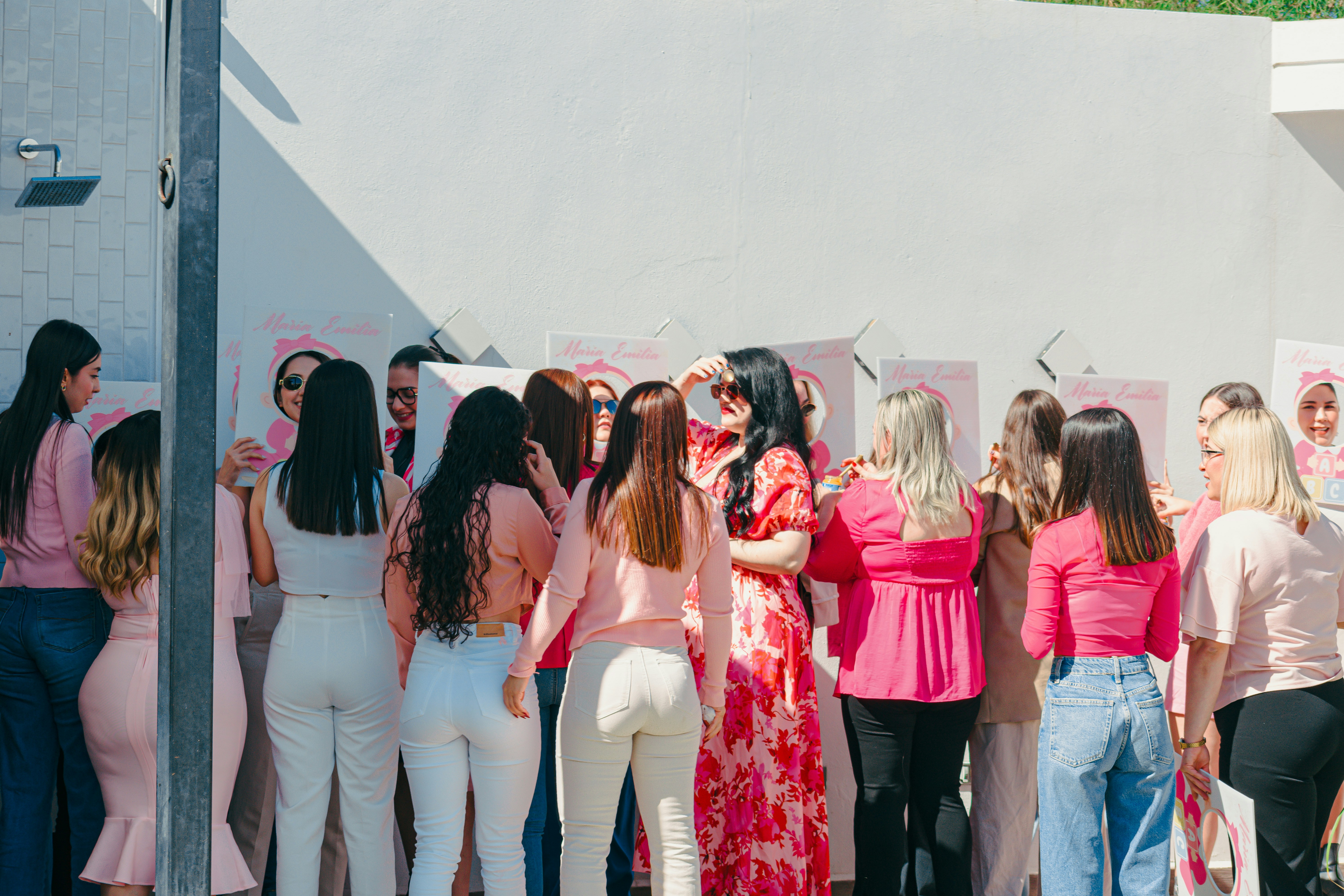 A group of women in pink gathered outdoors