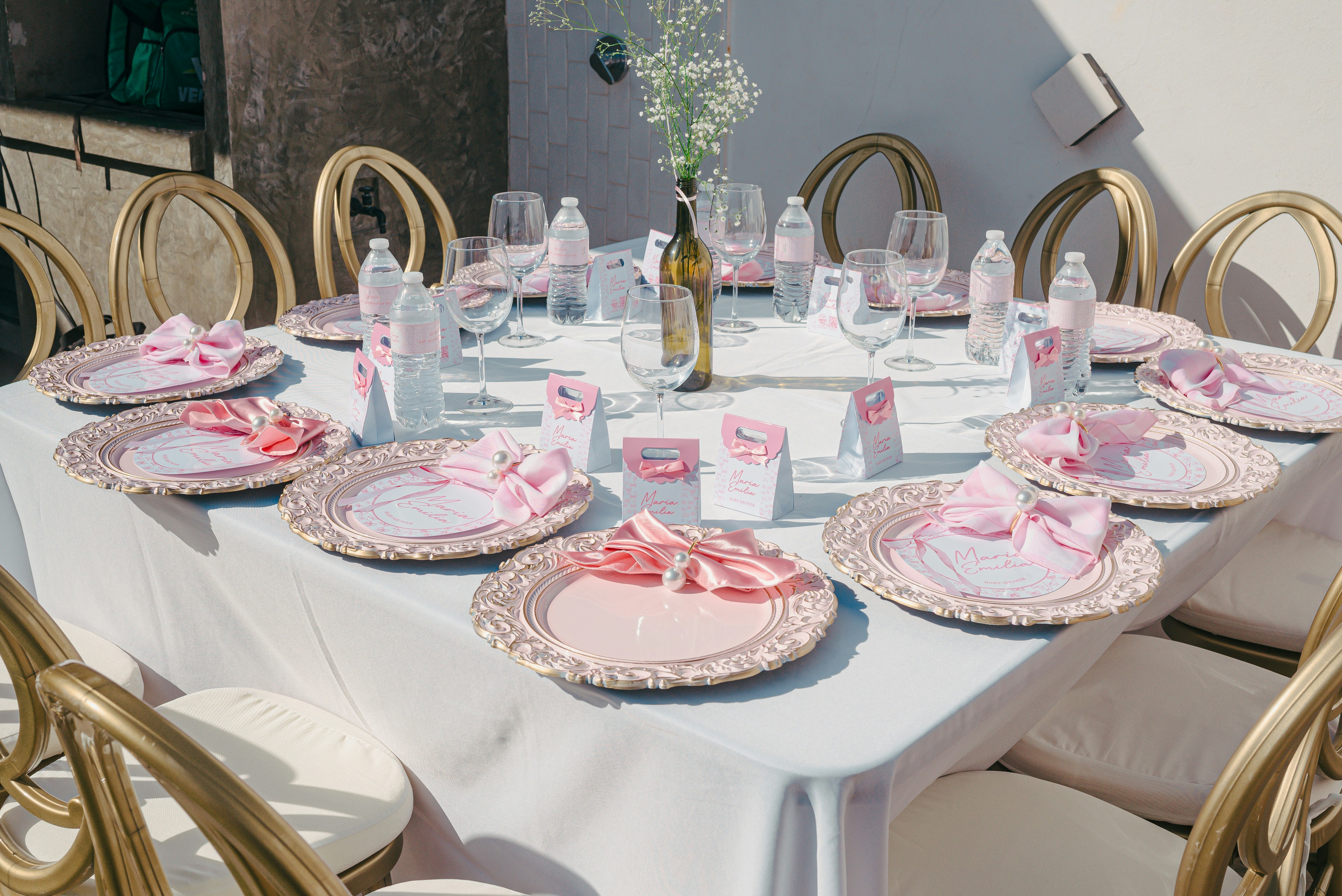 A beautifully set table with pink accents for an event.