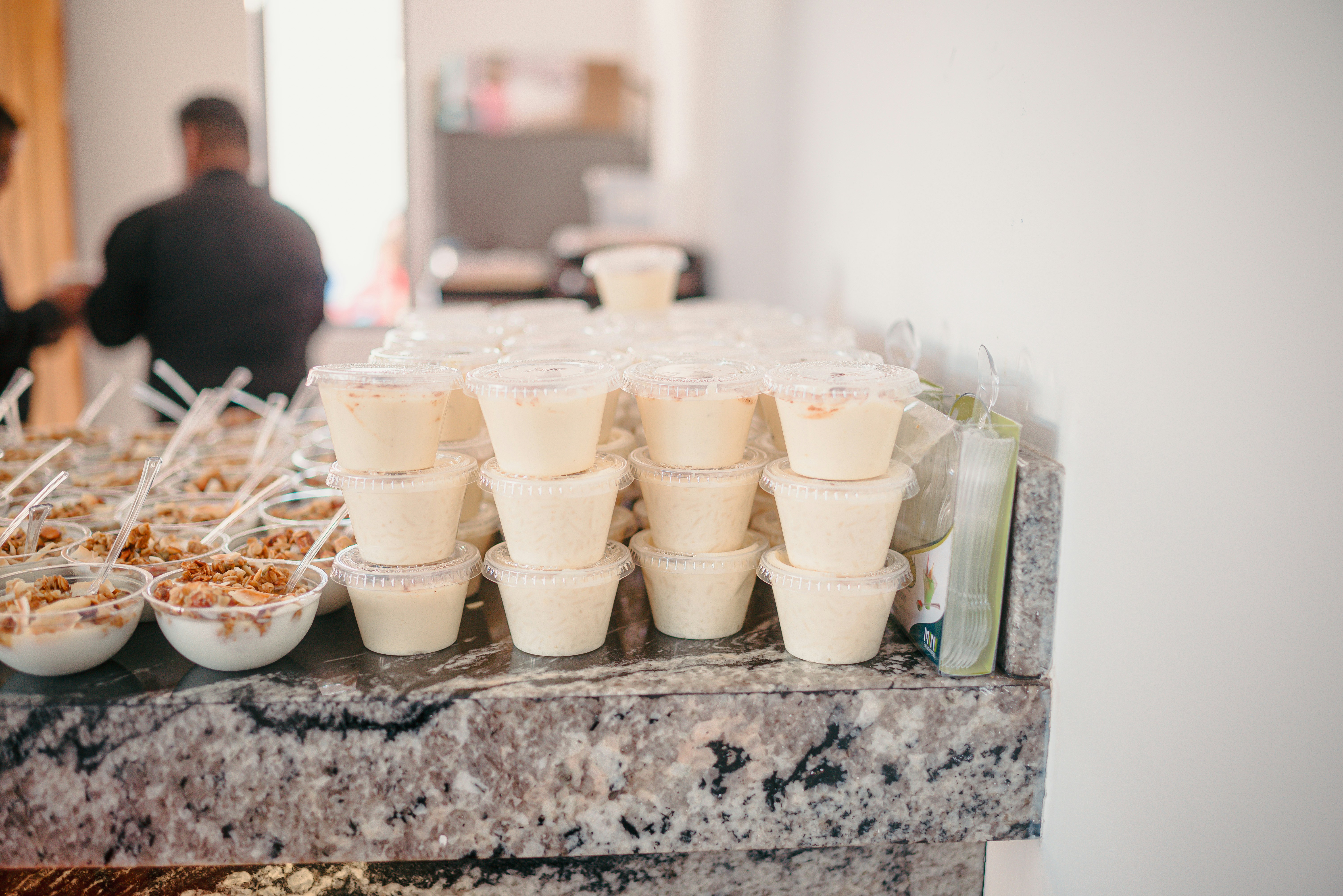 Small white desserts stacked on a counter