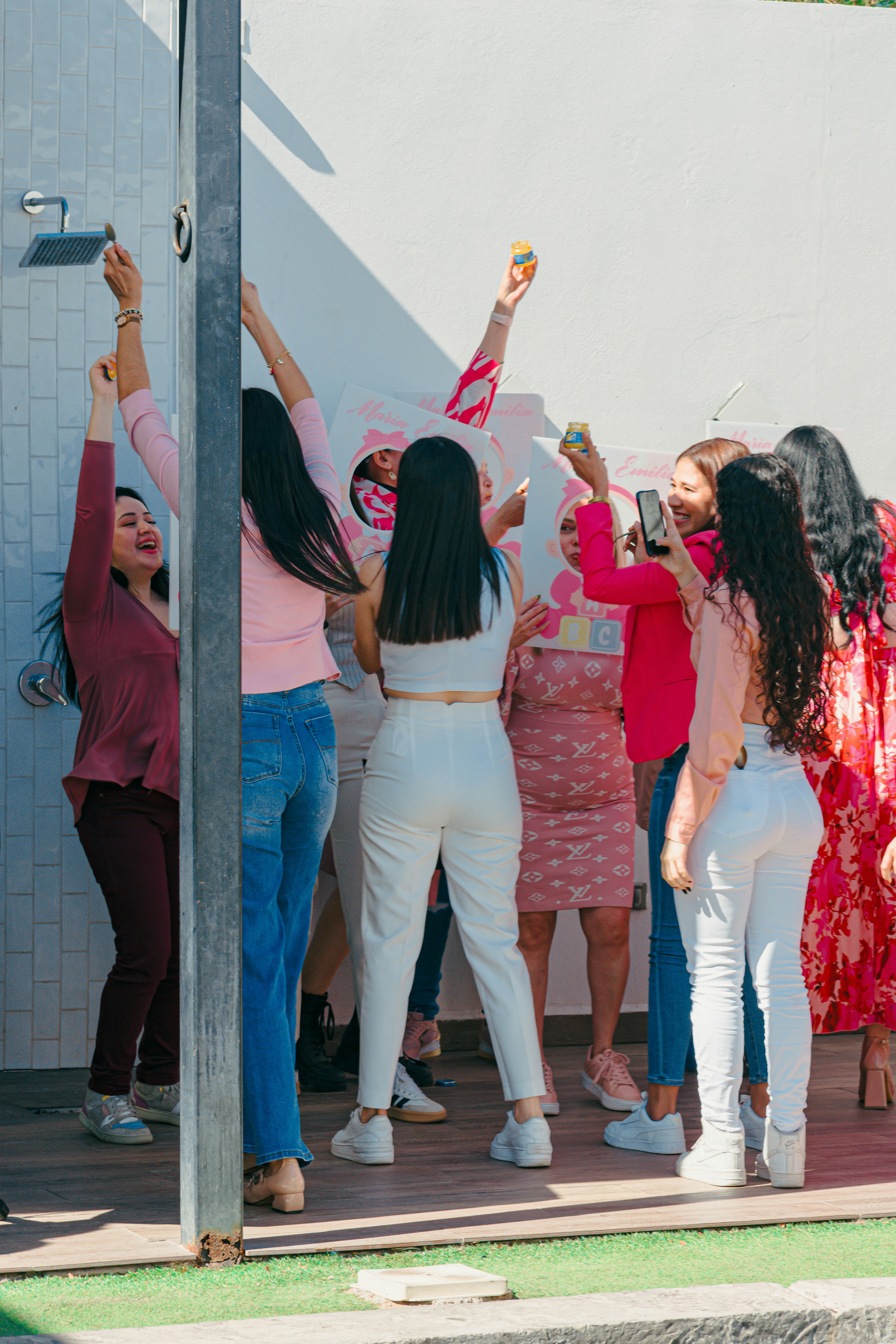 Group of women celebrating with drinks outdoors