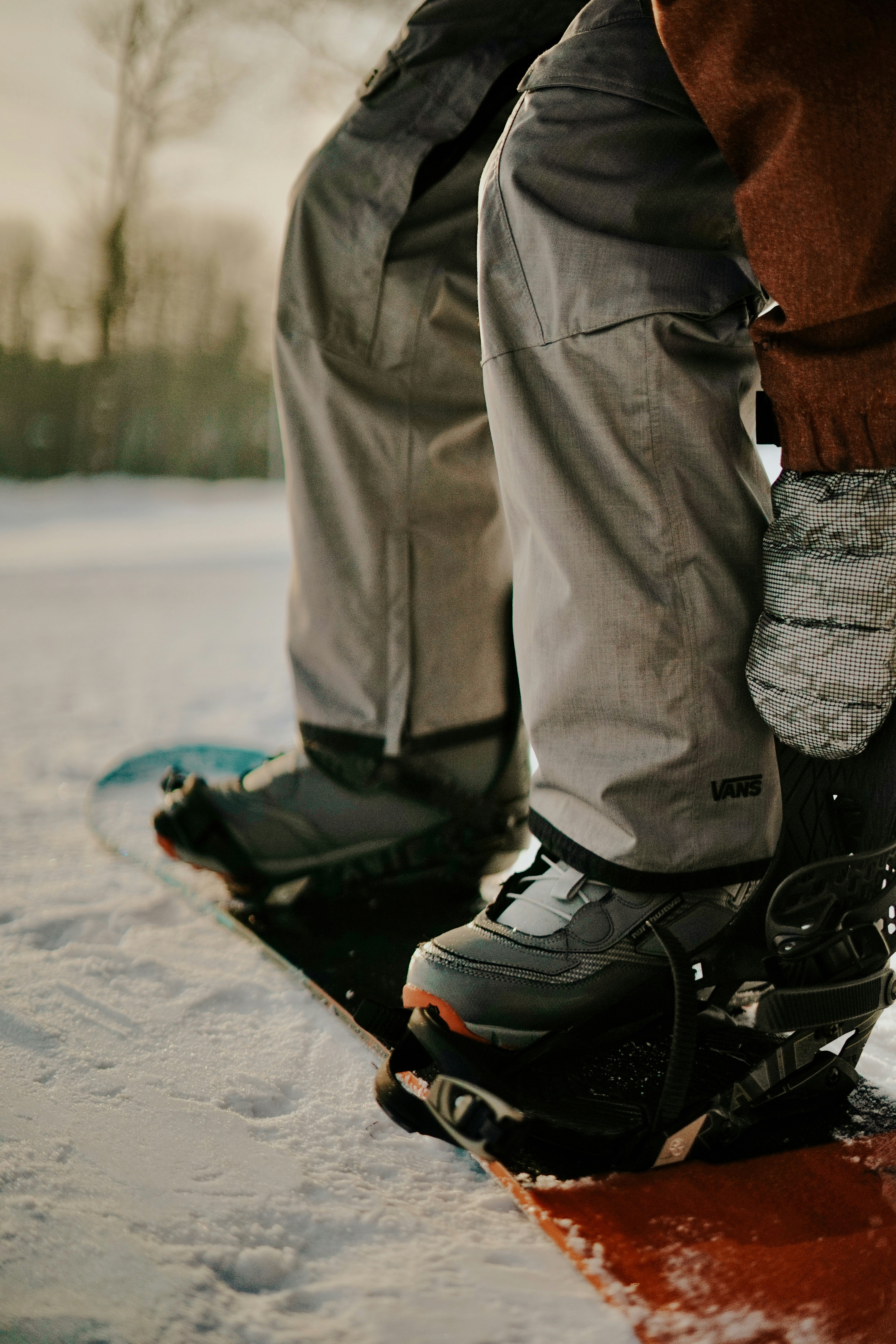 Two people on a snowboard in the snow