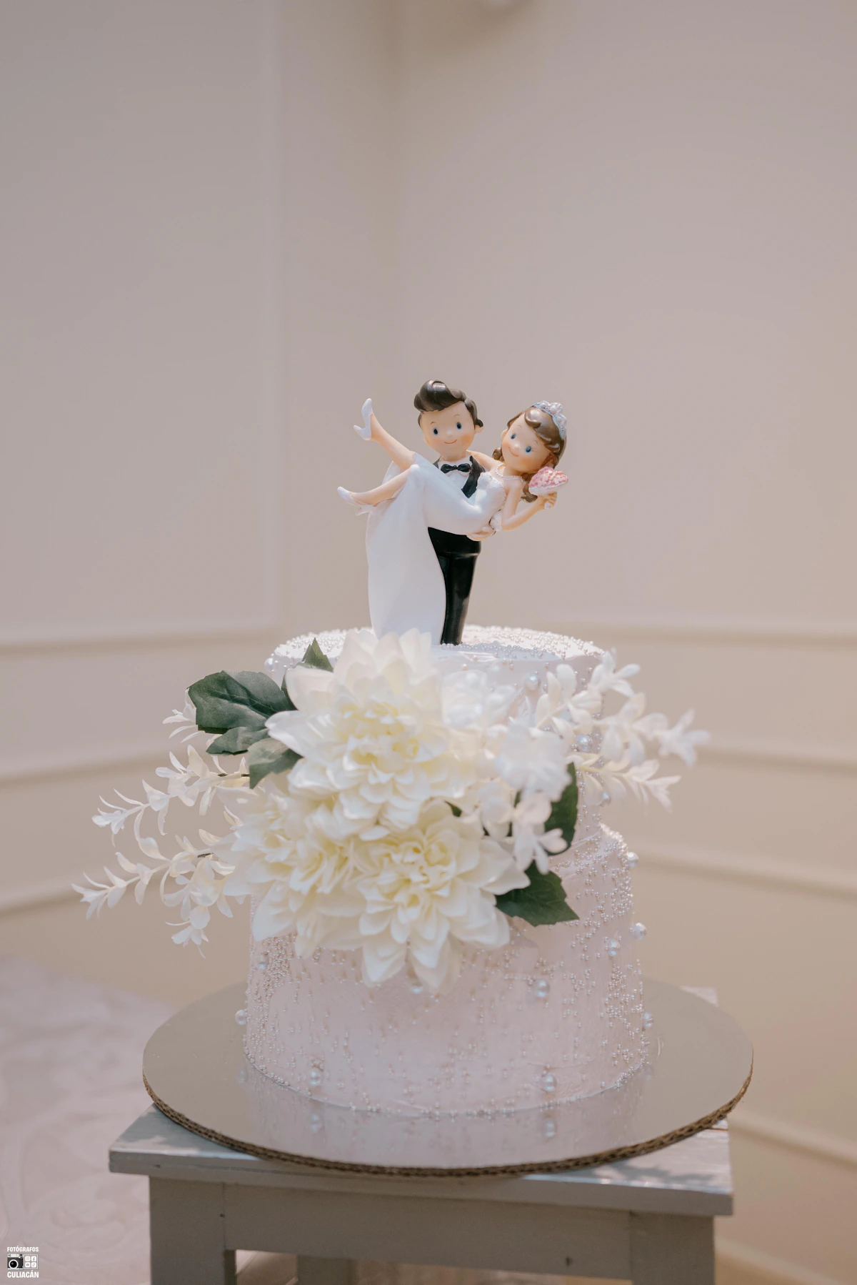 Elegant white wedding cake with white flowers