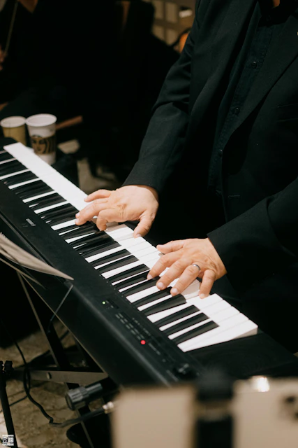 Musician plays a digital piano with both hands