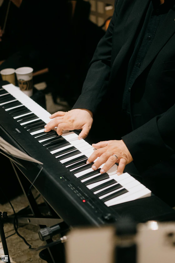 Musician plays a digital piano with both hands