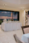 Decorated wedding table overlooking a city at sunset