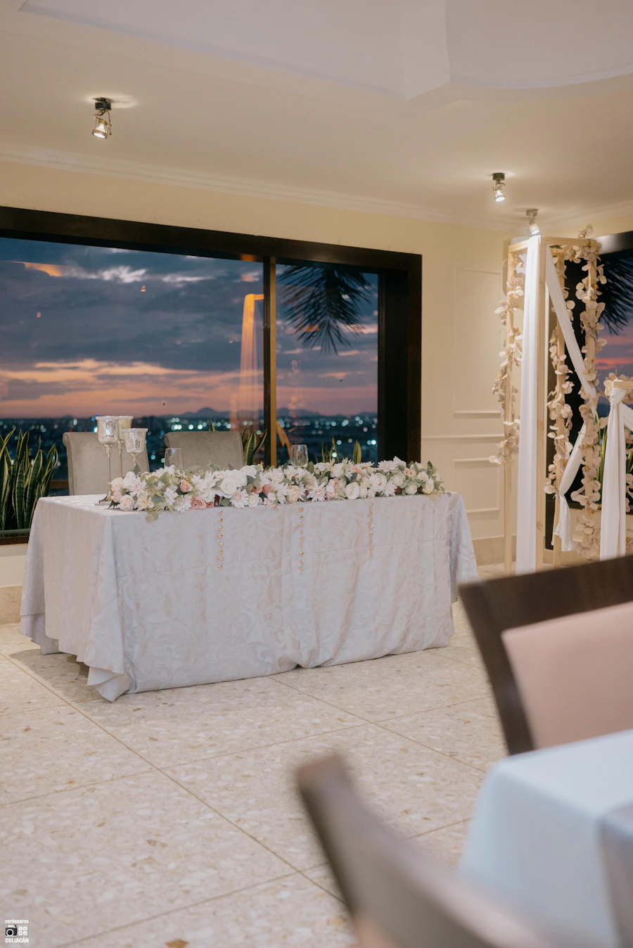 Elegant wedding table with flowers overlooking a city at golden hour