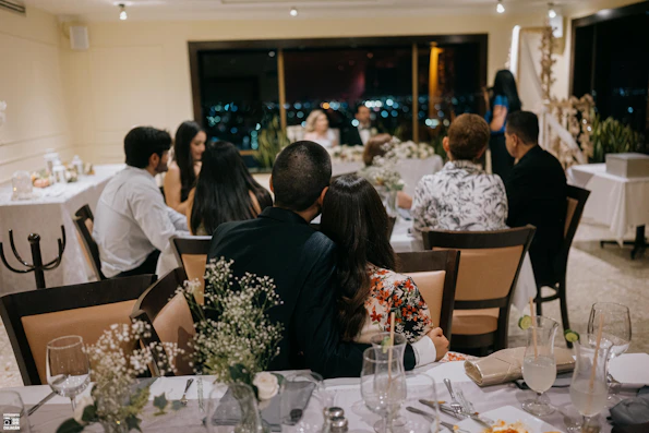 Wedding guests seated at decorated tables at night.