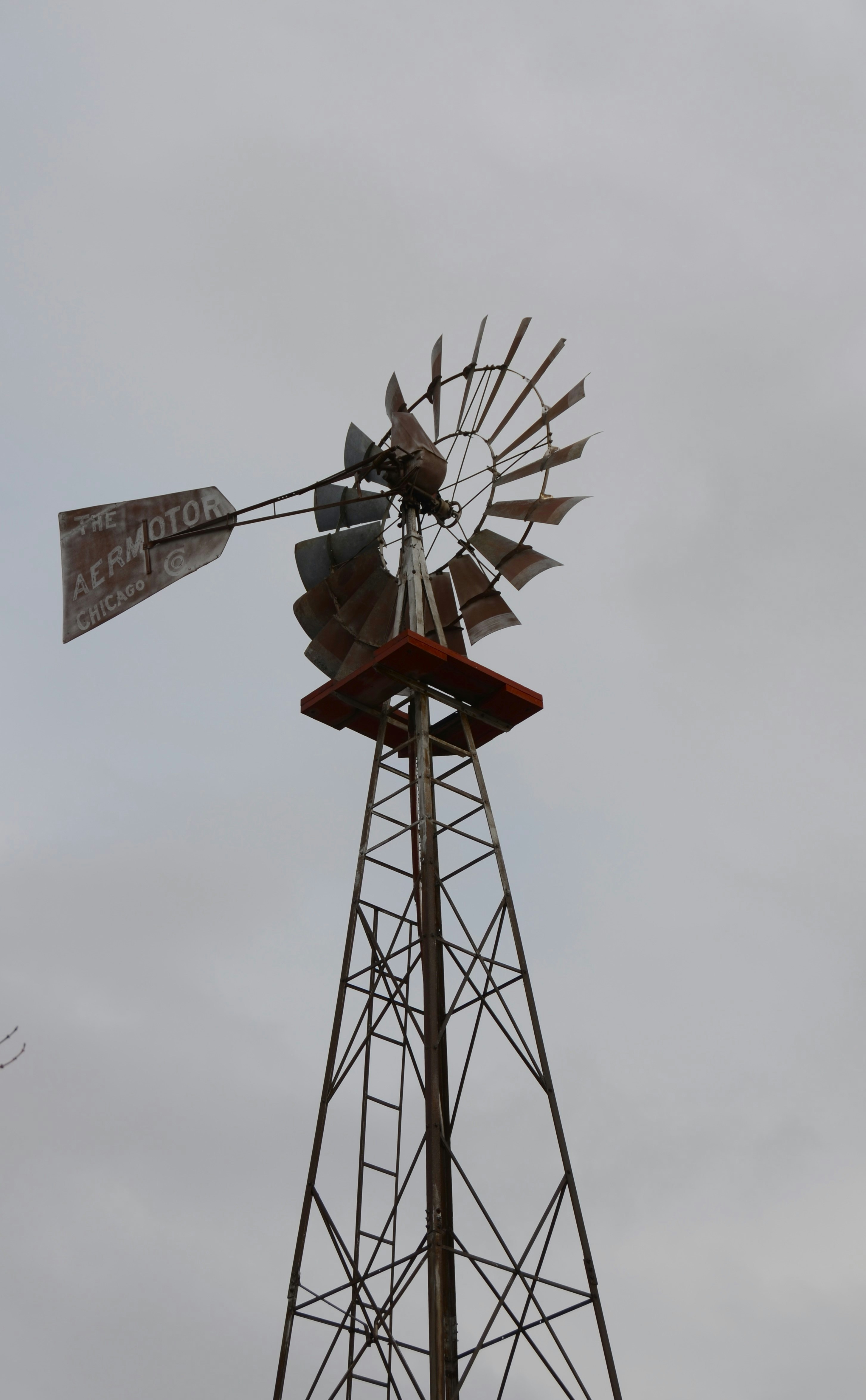 A vintage windmill against a cloudy sky