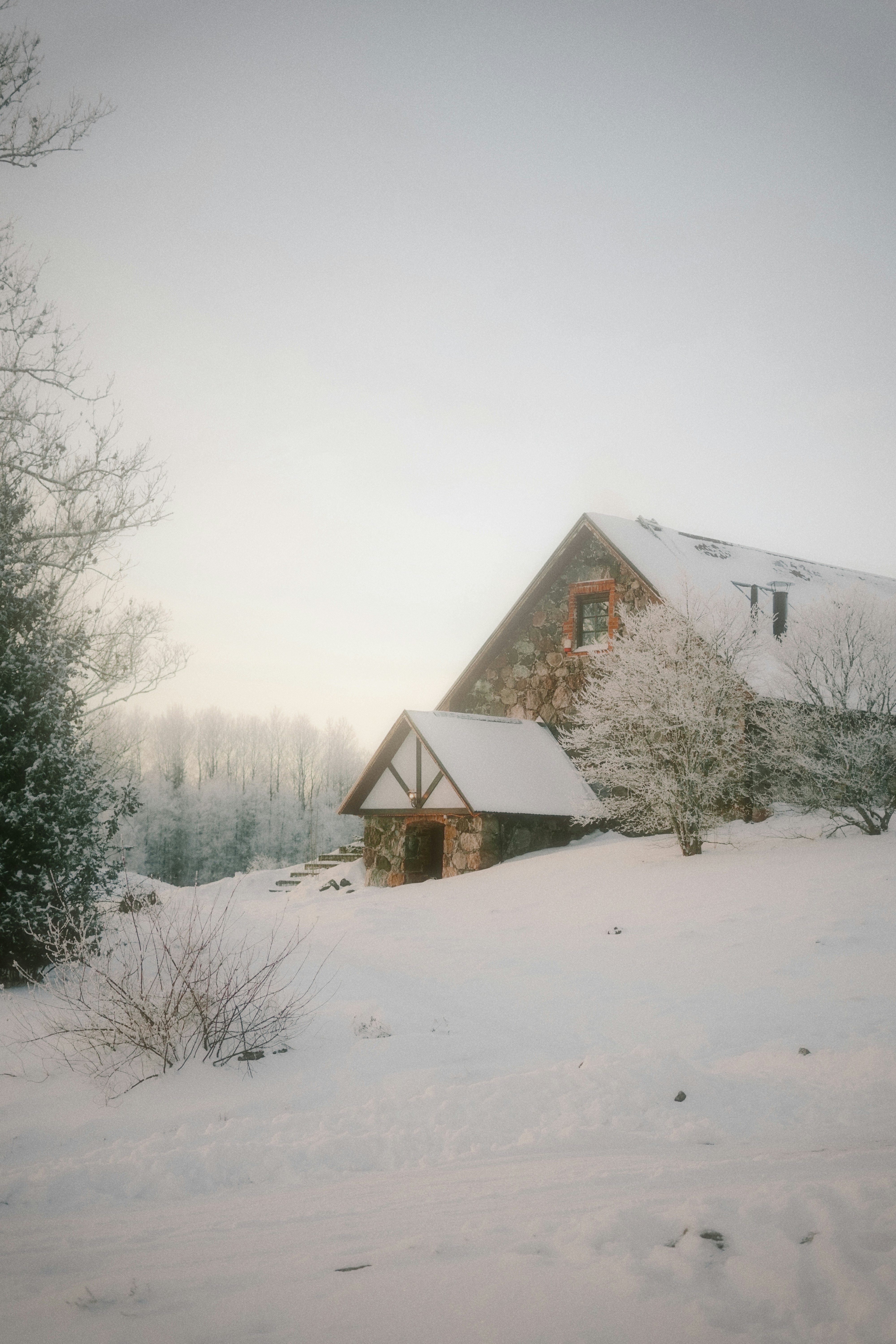 Snow covered stone house on a winter day