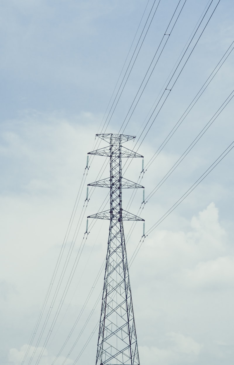 Tall power line tower against a cloudy sky