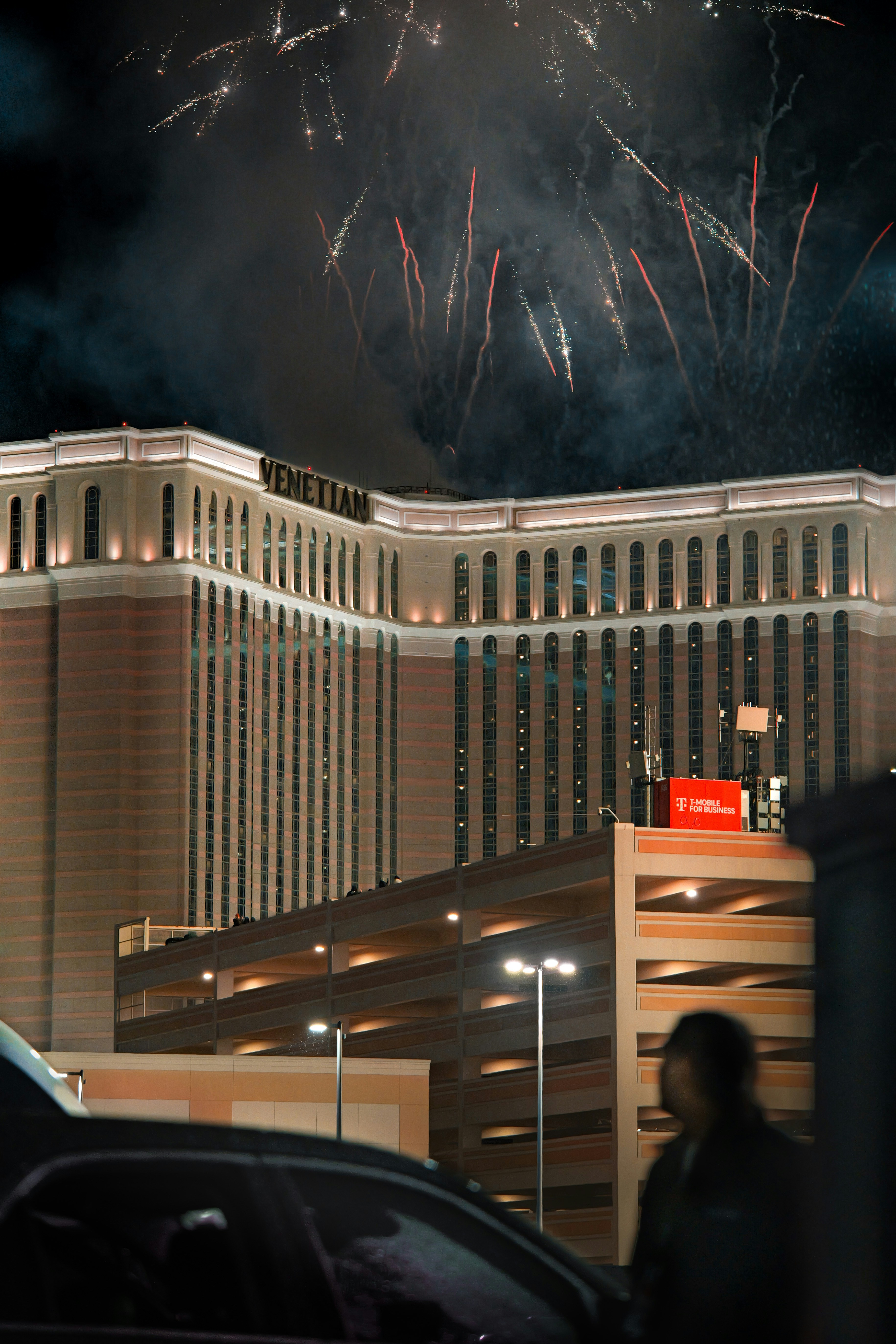 Fireworks explode over the venetian hotel at night.