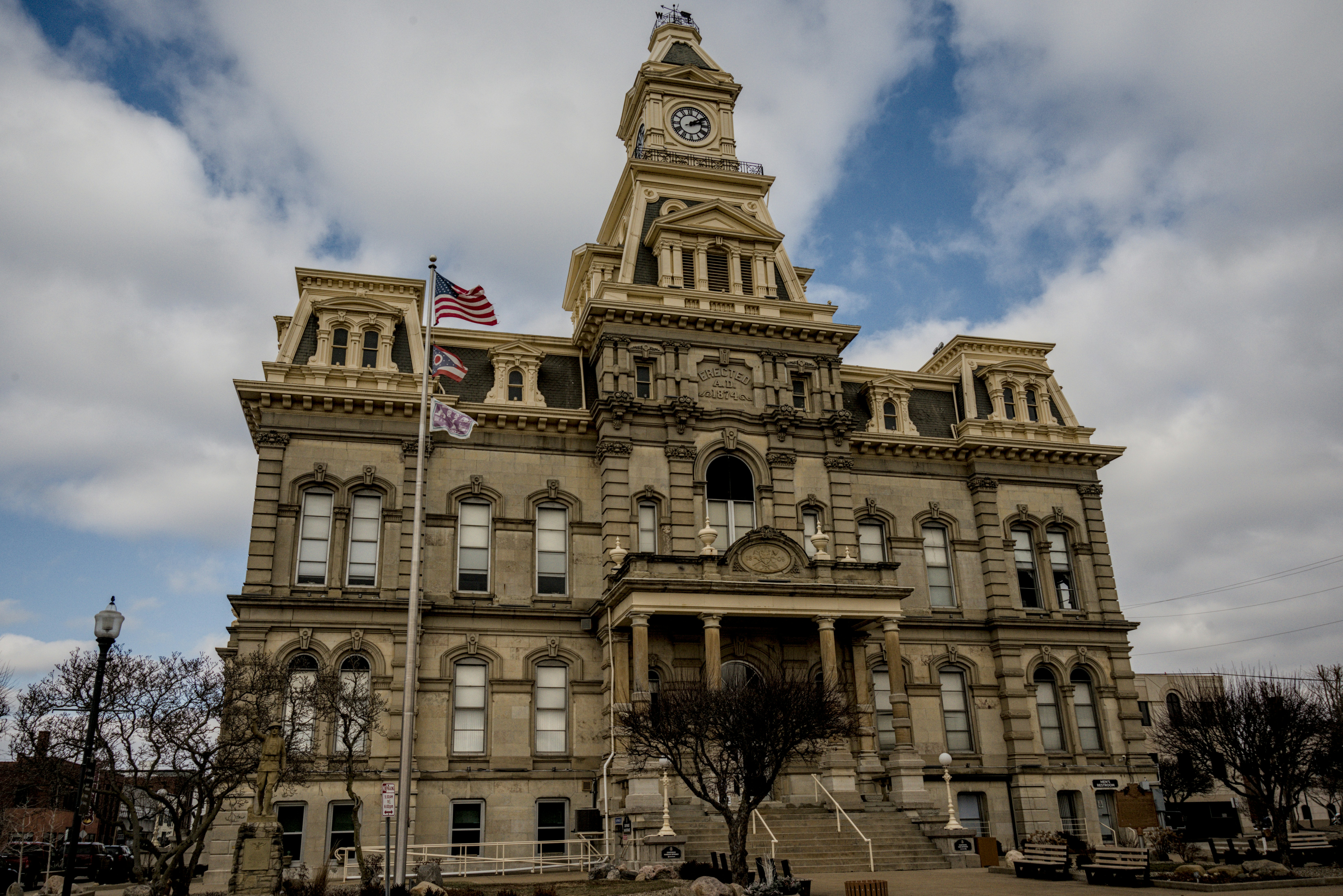 Ornate historic building with a clock tower and flag.
