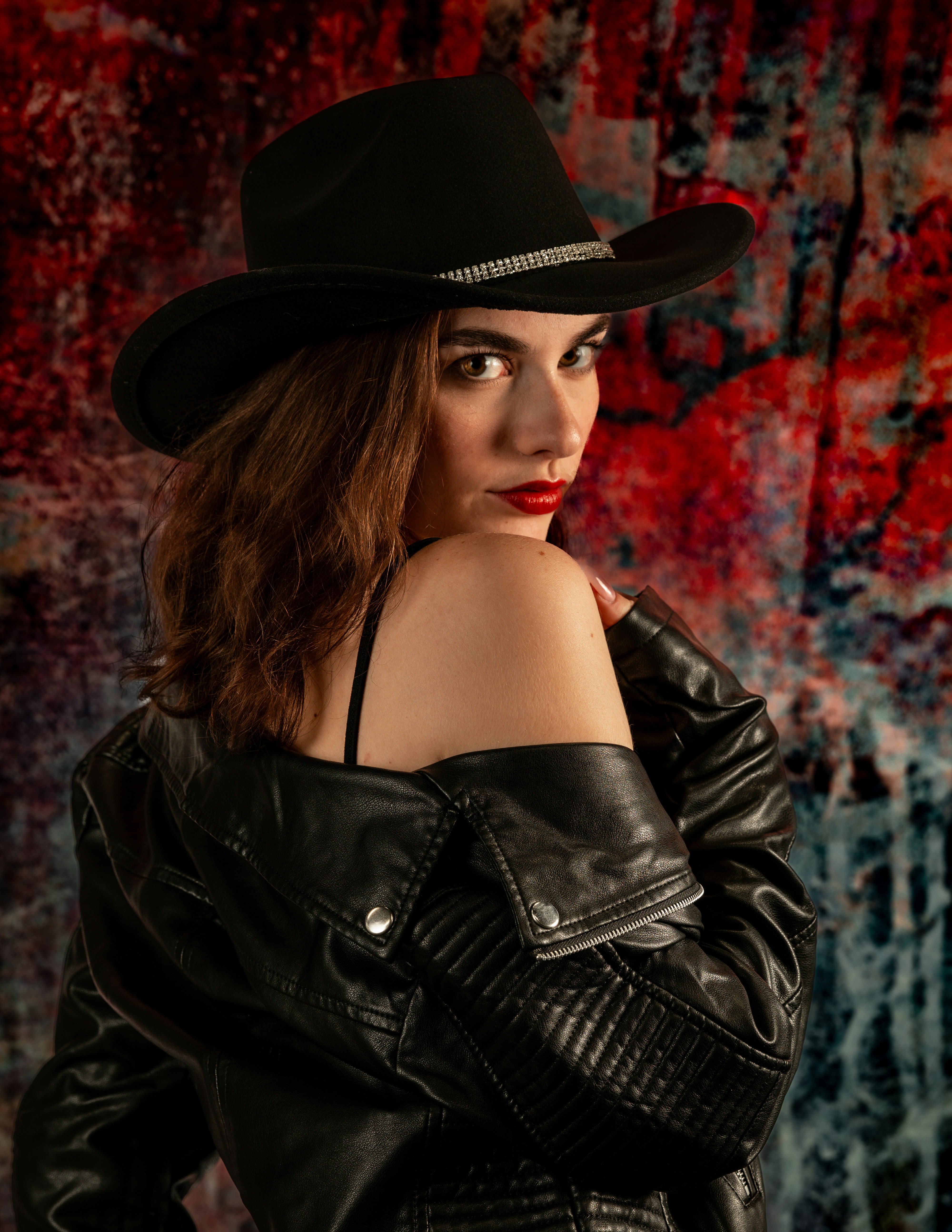 Woman in black cowboy hat and leather jacket