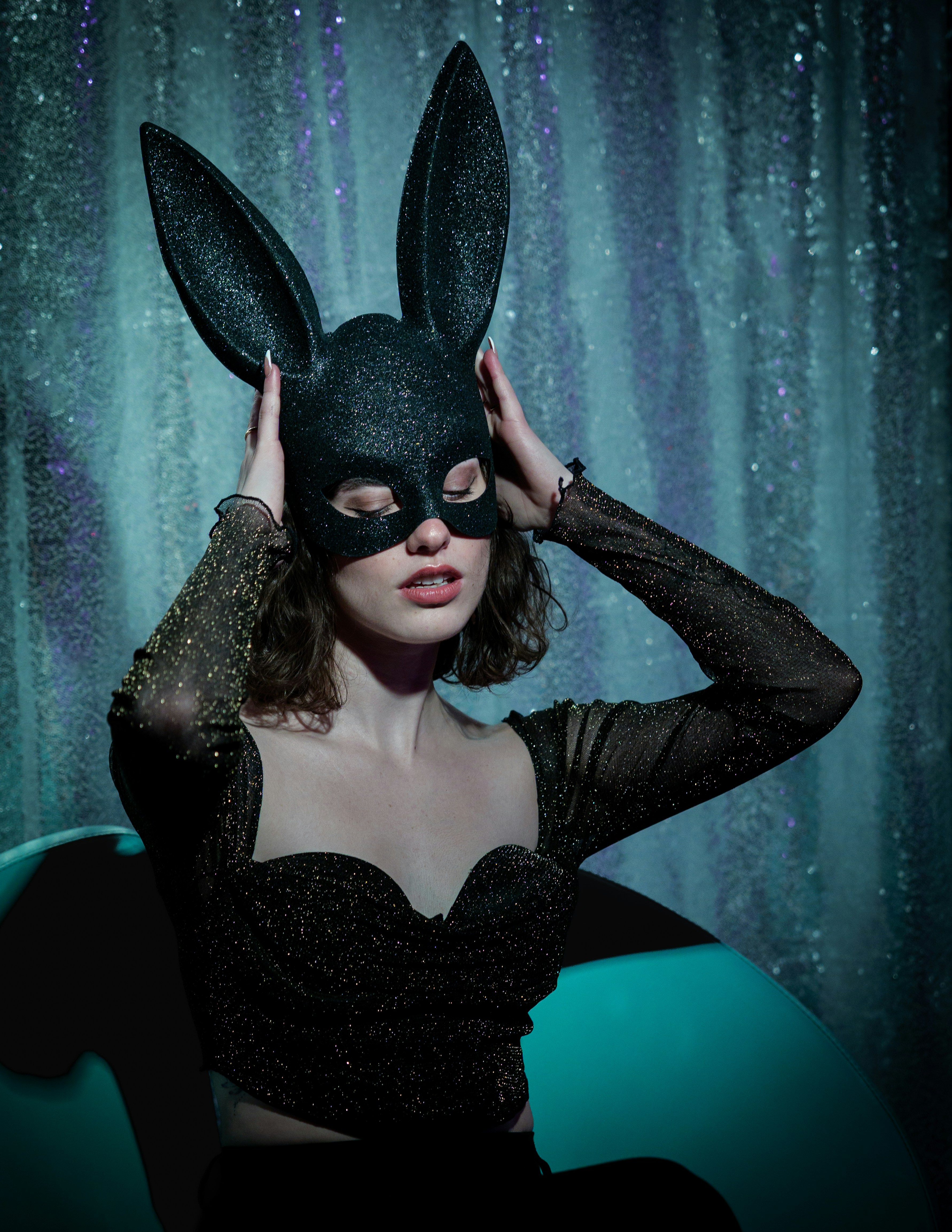 Woman wearing a sparkly bunny mask and top