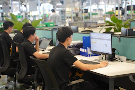 Workers at computers in a modern office setting