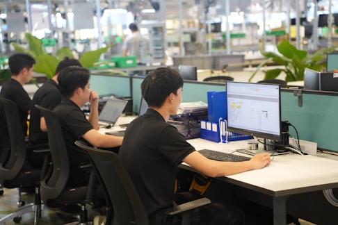 Workers at computers in a modern office setting