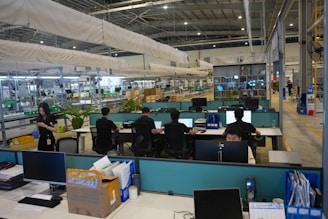 People working at computers in a modern office space.