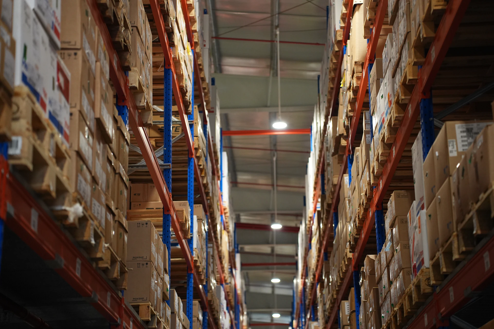 Rows of shelves stacked with boxes in a warehouse.