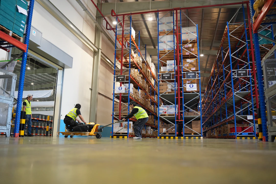 Clean, brightly lit modern logistics warehouse with tall shelves.