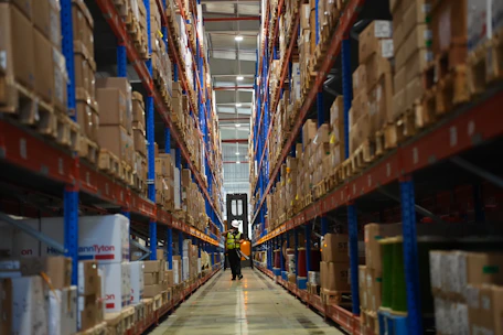 Rows of shelves filled with boxes in a warehouse.
