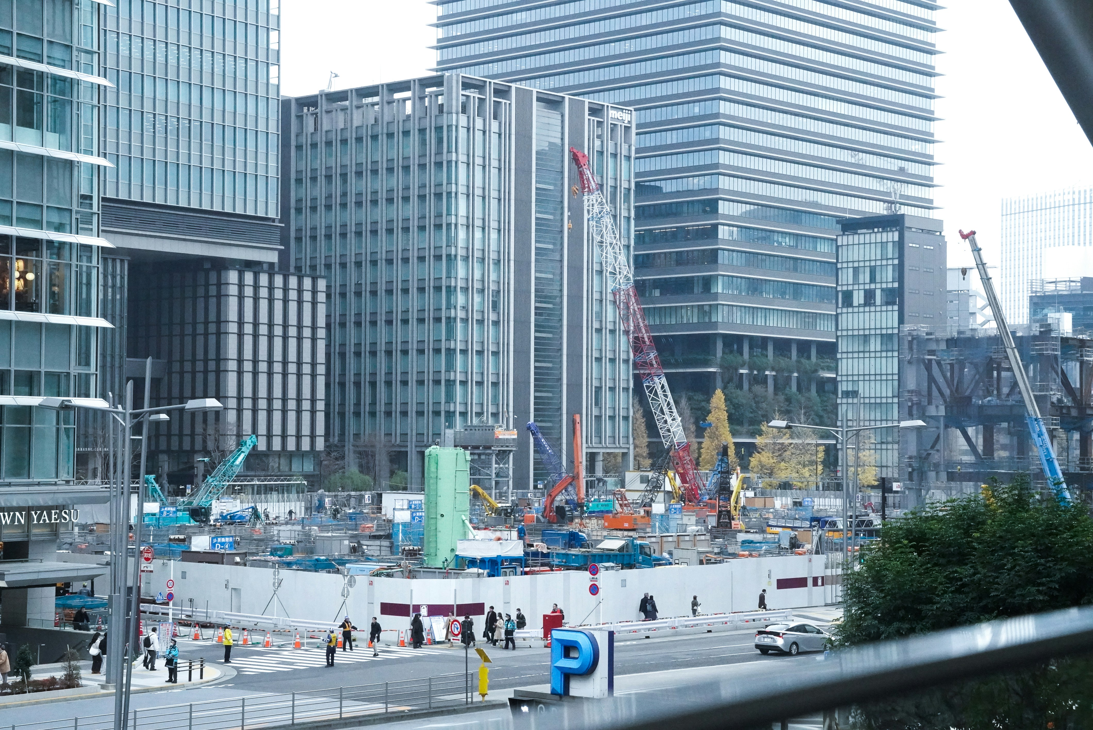 Construction site with cranes and buildings in the background