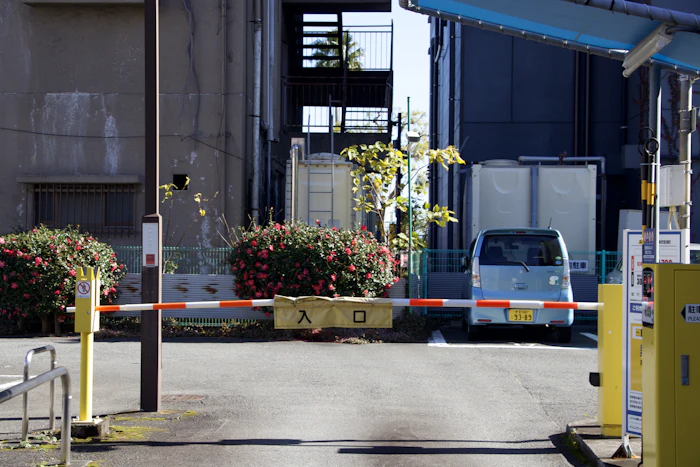 A van waiting behind a closed barrier