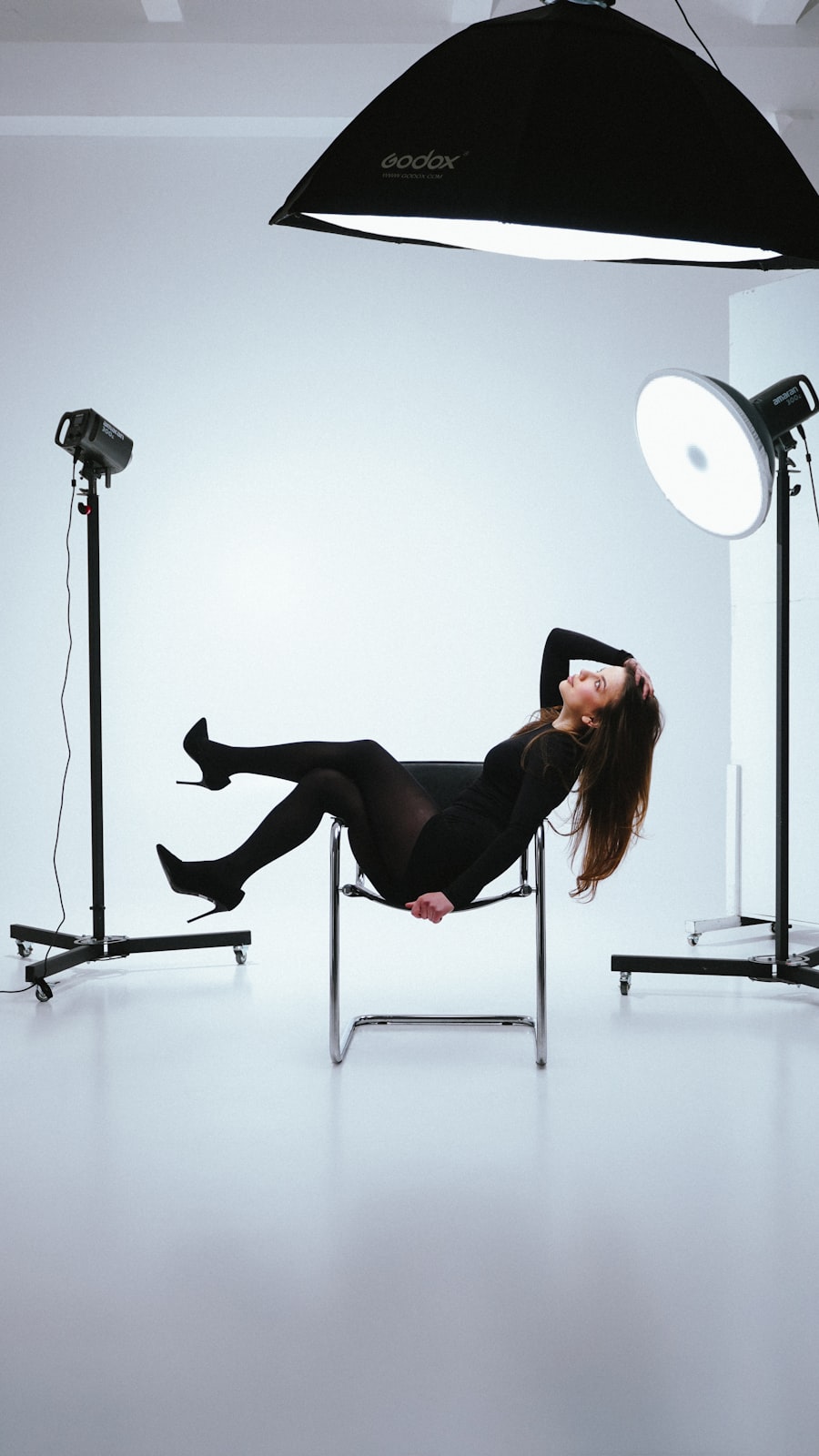 Professional fashion photography studio with model and lighting setup