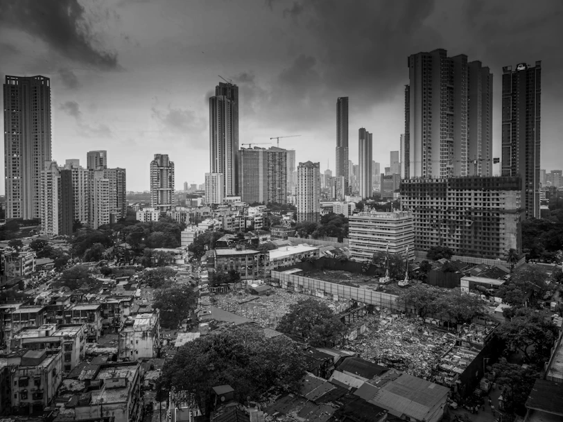 Monochrome cityscape with modern high-rise buildings and older structures.