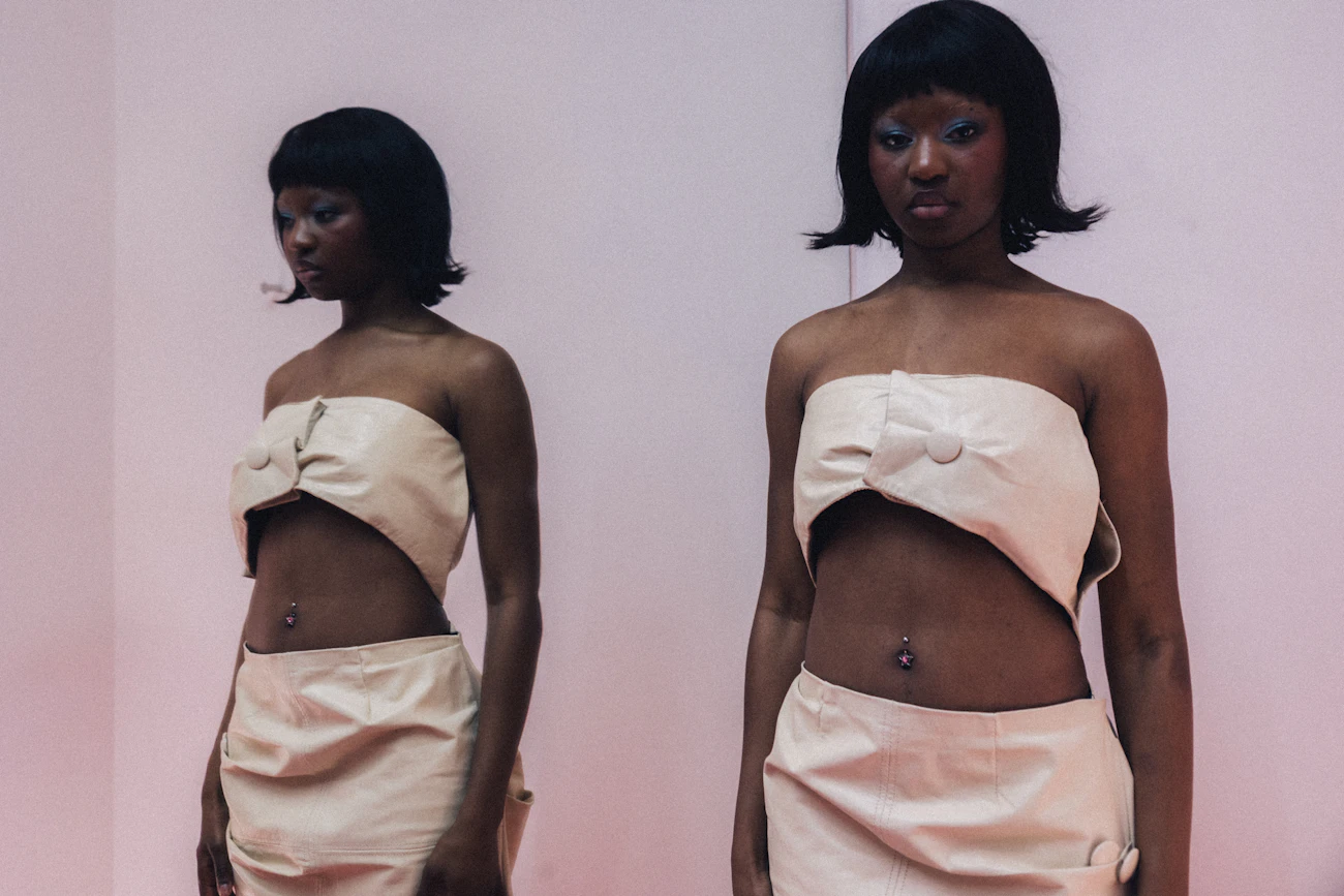 Woman in a cream fashion look against a minimalist studio background