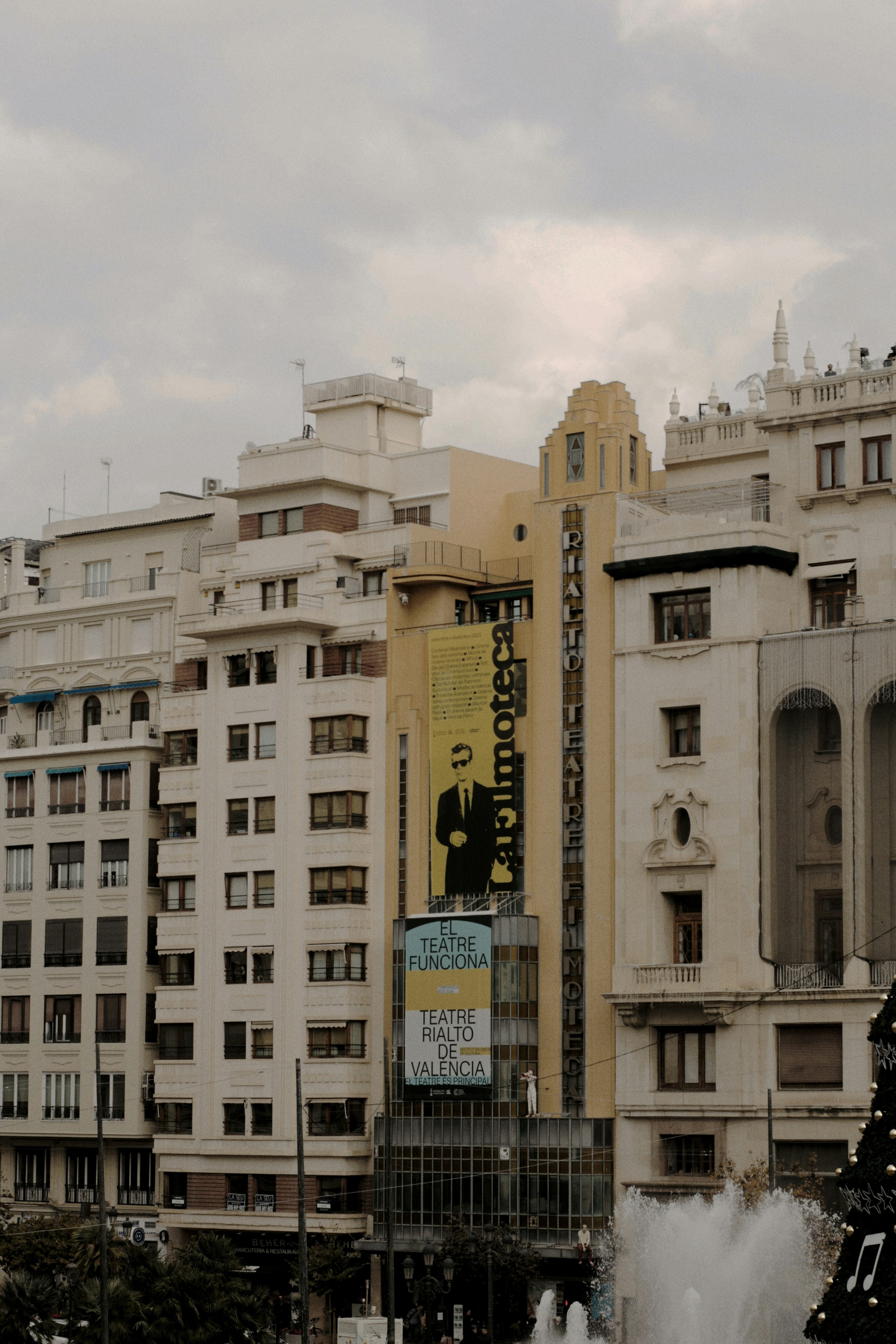 Tall buildings with a large billboard in a city.