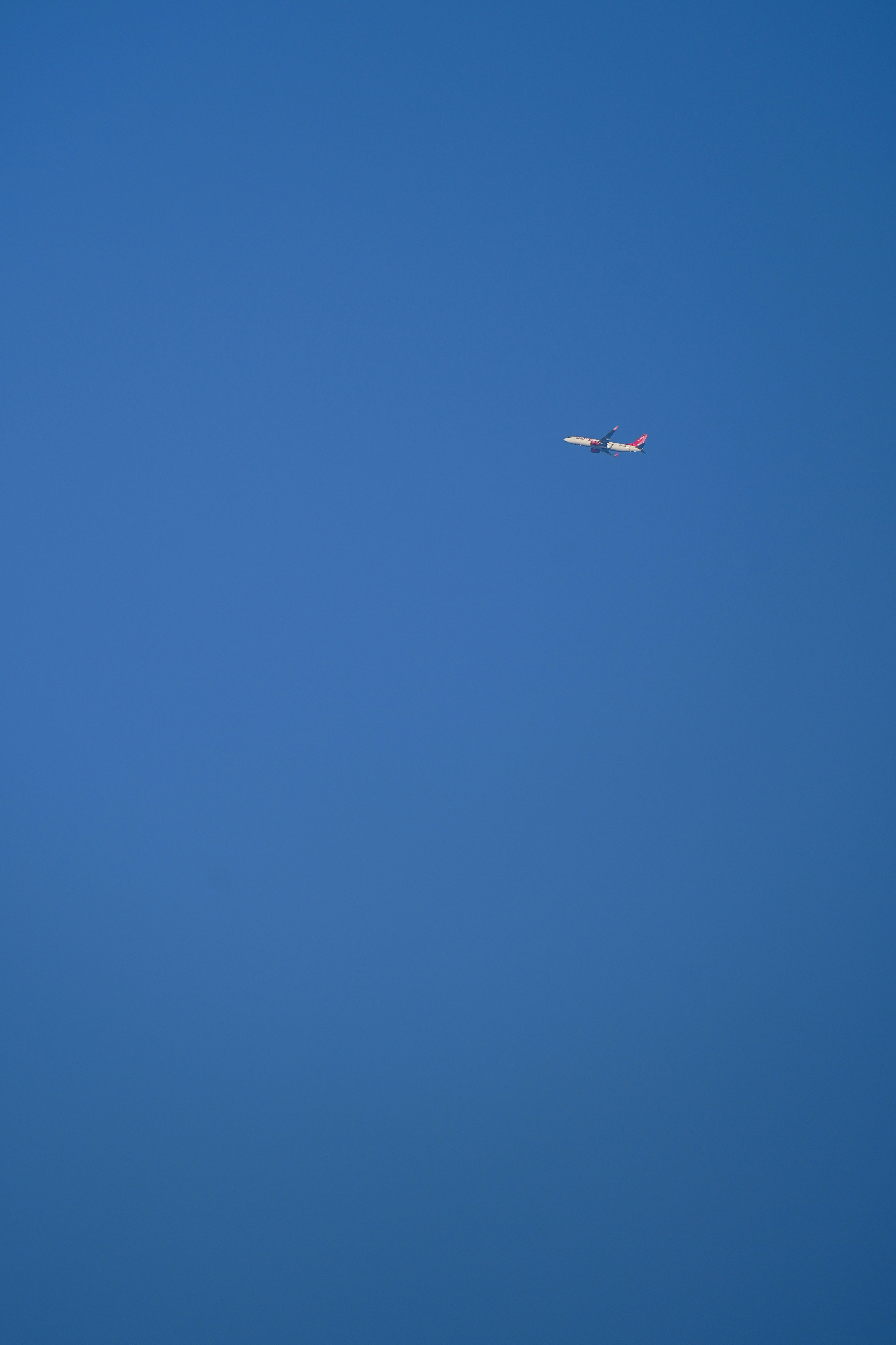An airplane flying in a clear blue sky