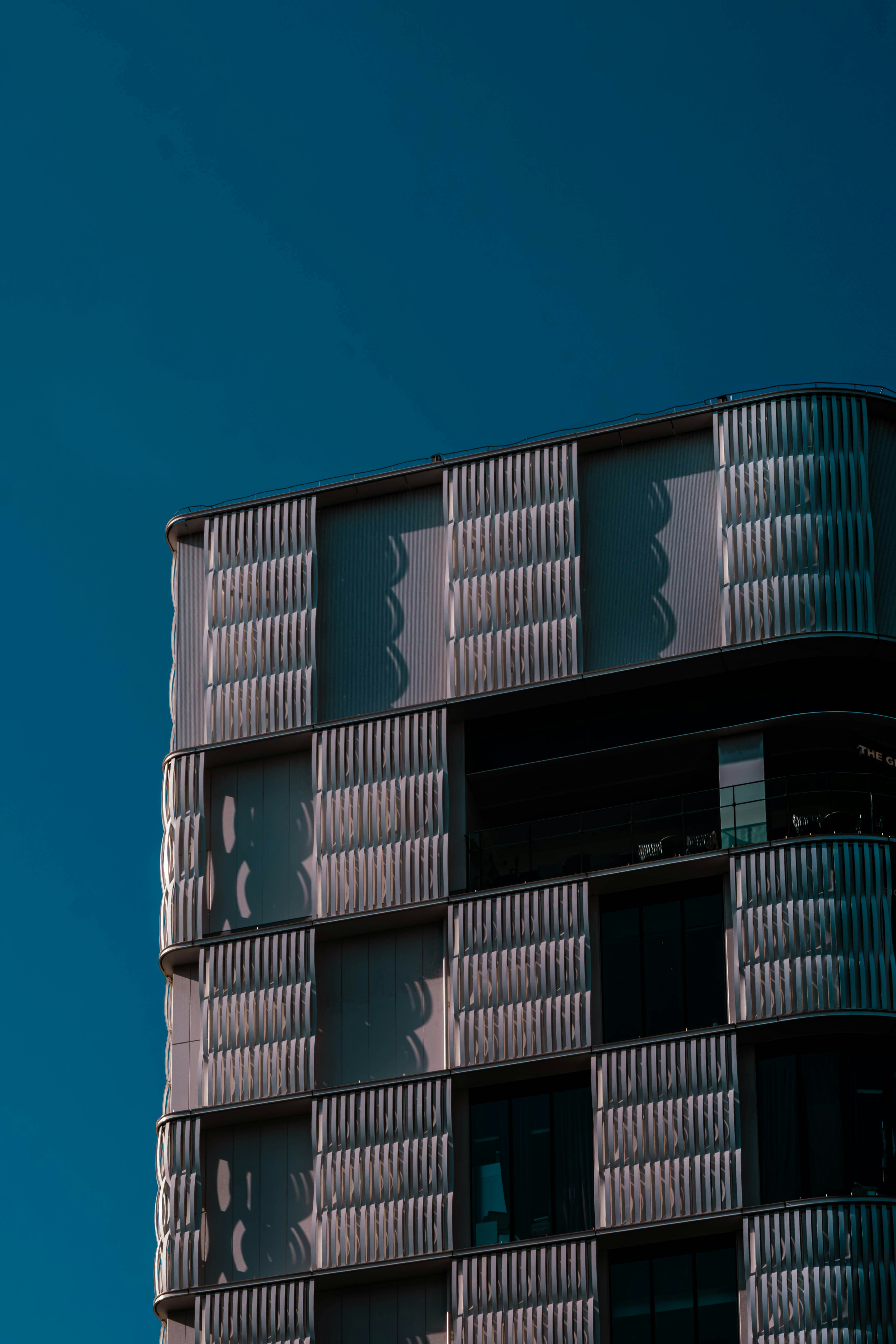 Modern building facade against a clear blue sky.