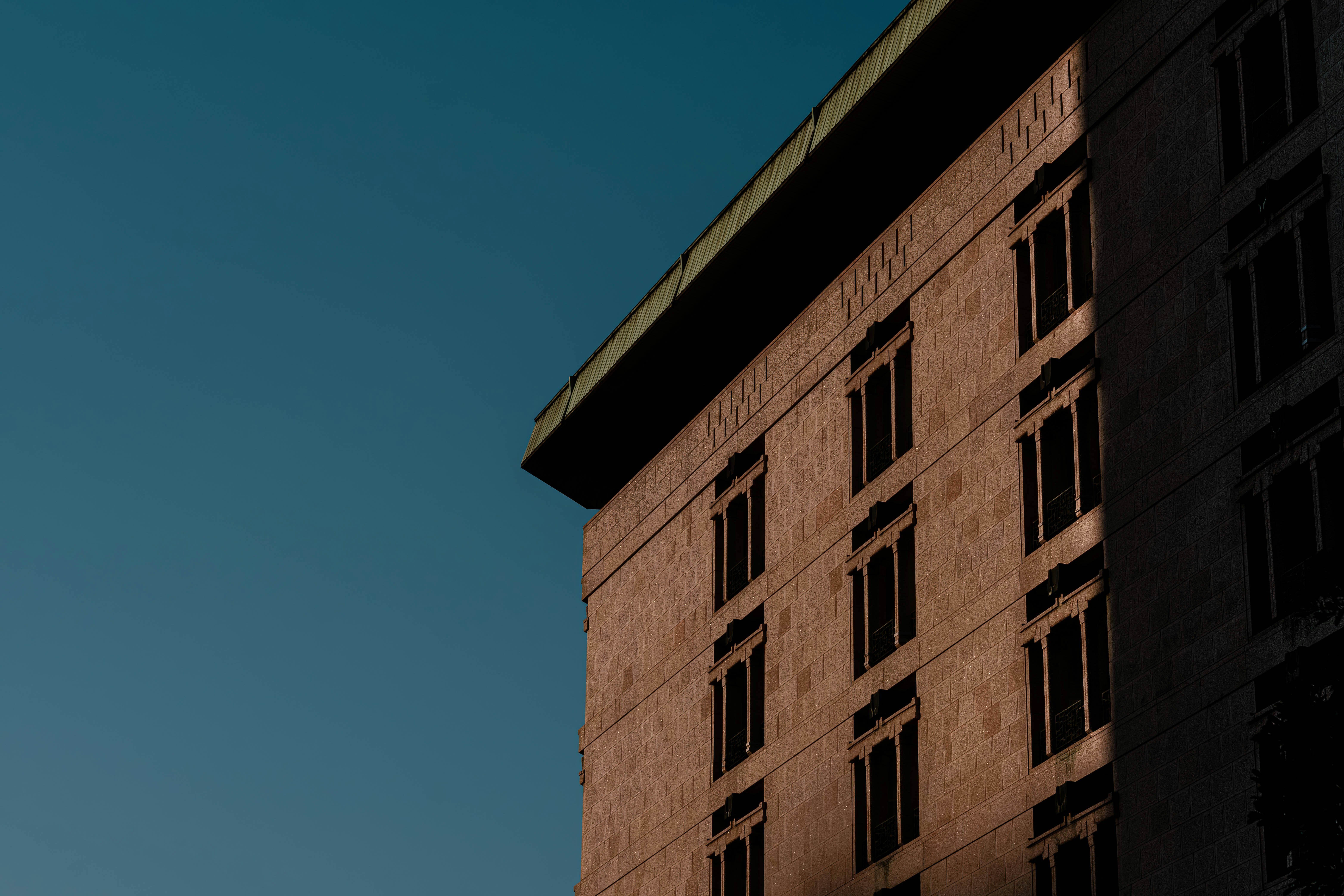 Corner of a building against a clear blue sky