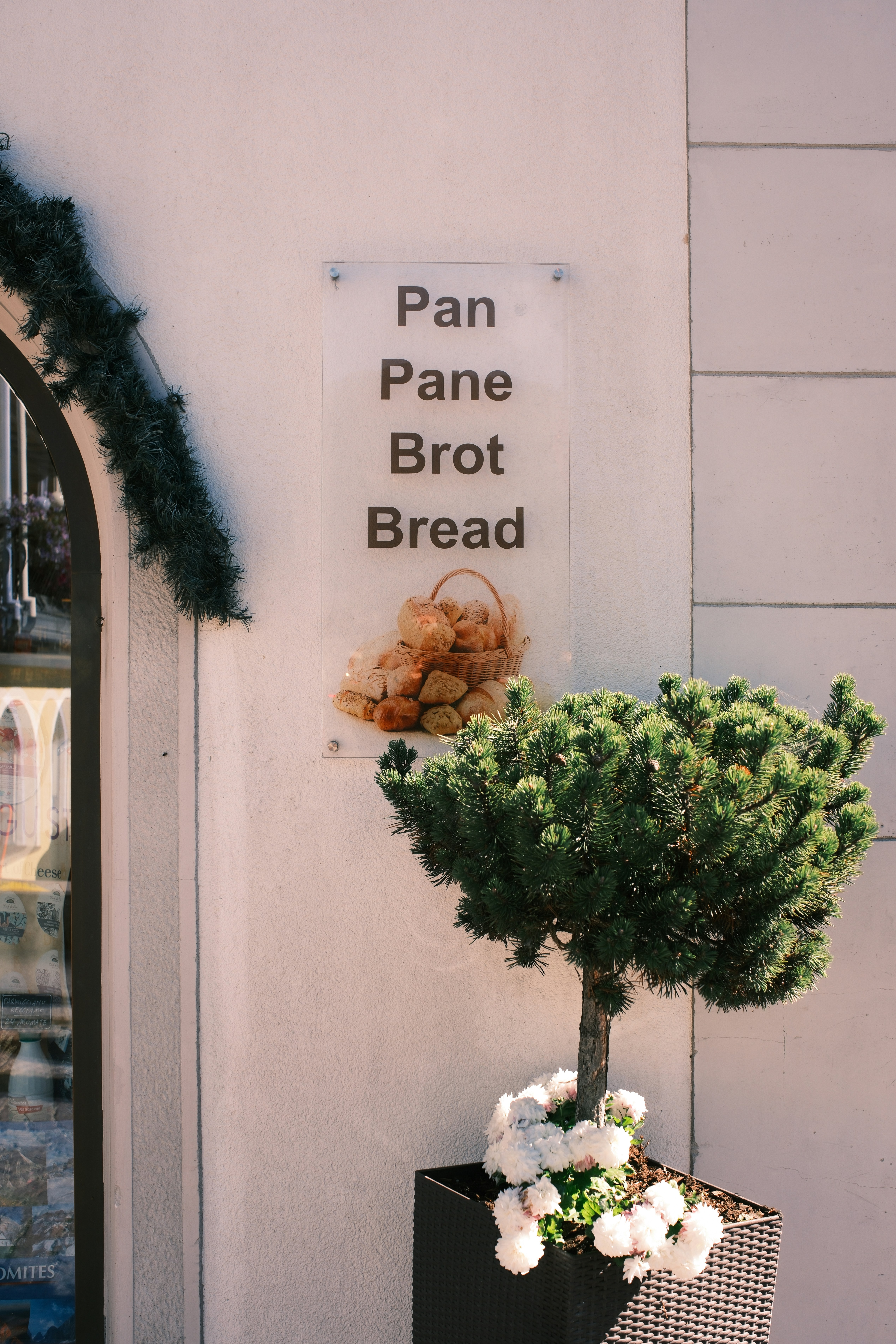 Bakery sign with bread basket and potted plant