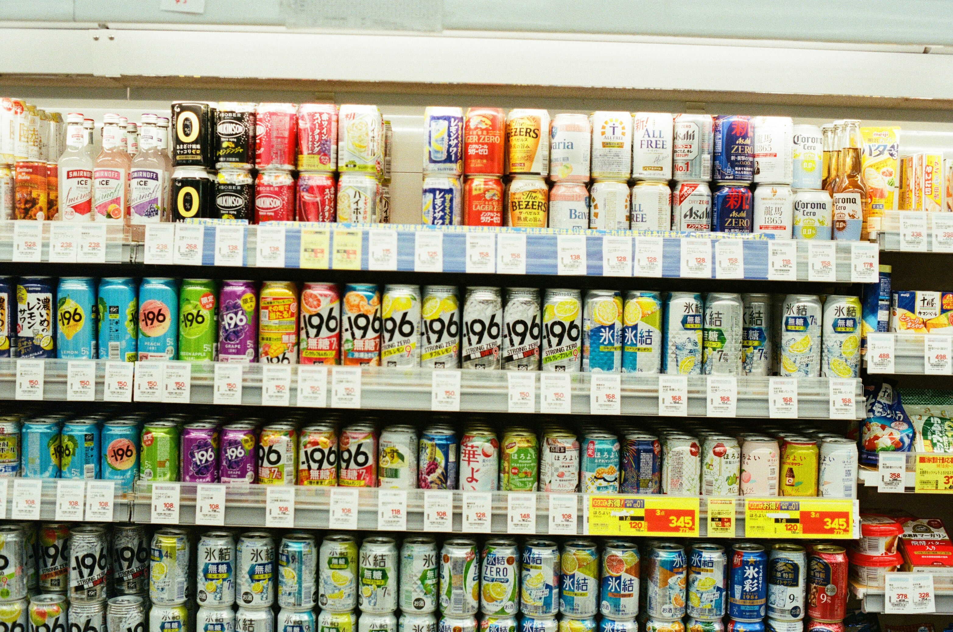 Shelves stocked with colorful beverage cans in a store.
