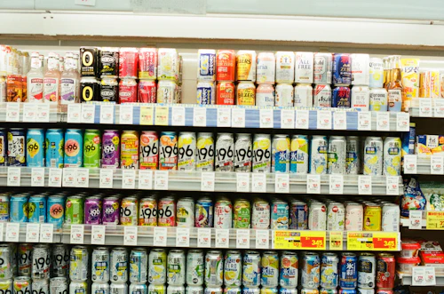 Store shelves stocked with rows of colorful beverage cans