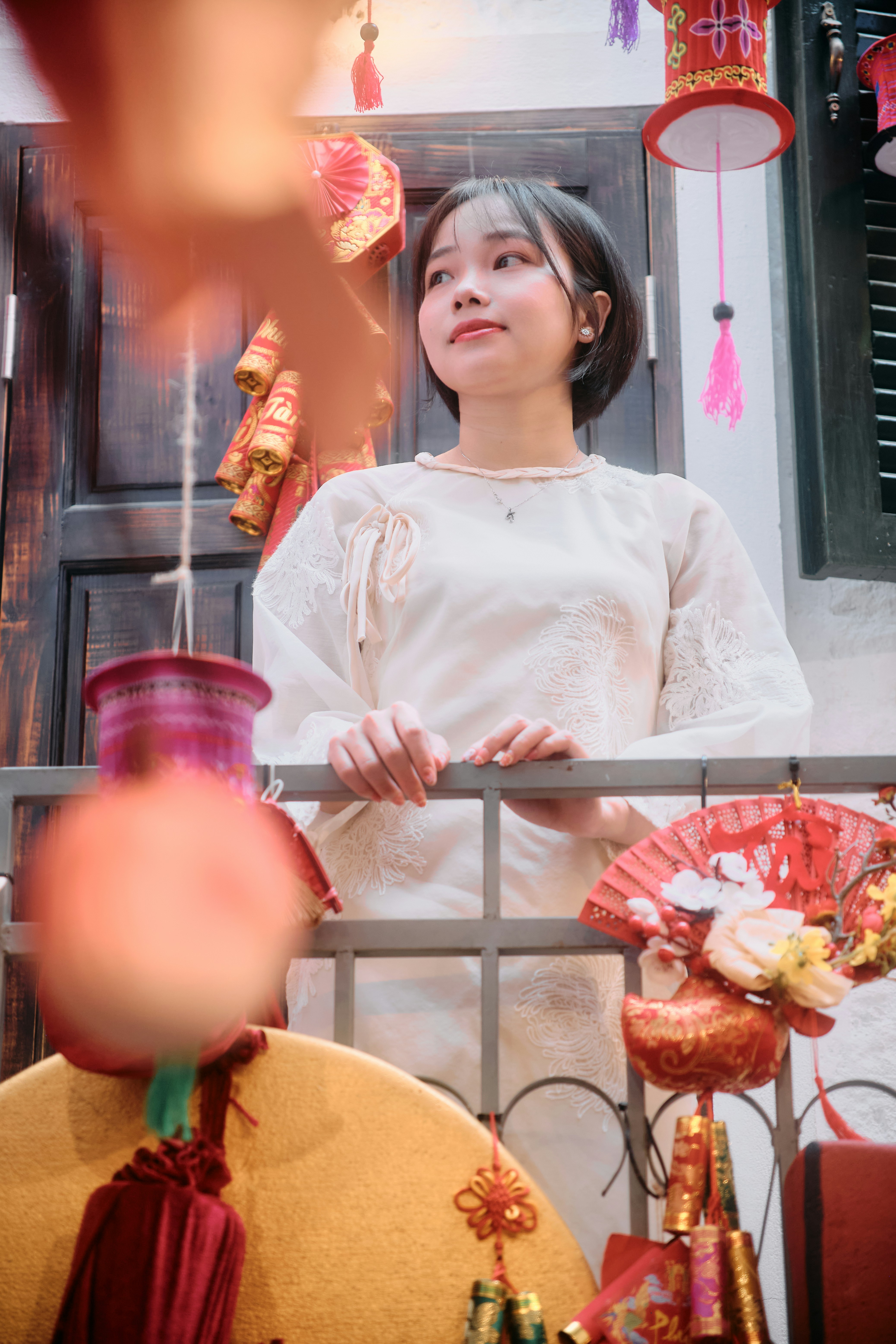 Young woman in traditional outfit surrounded by festive decorations