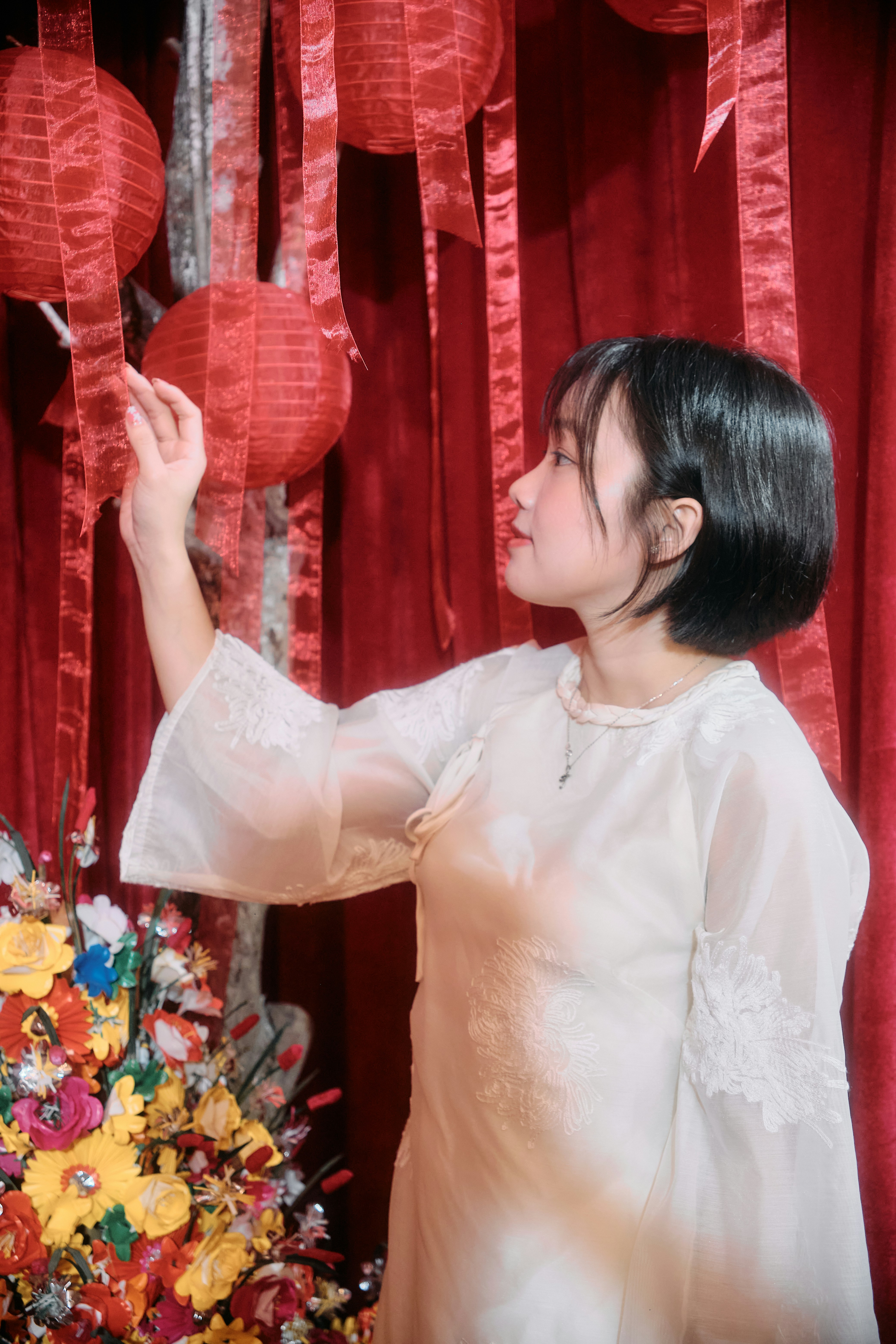 Young woman in white dress with red lanterns