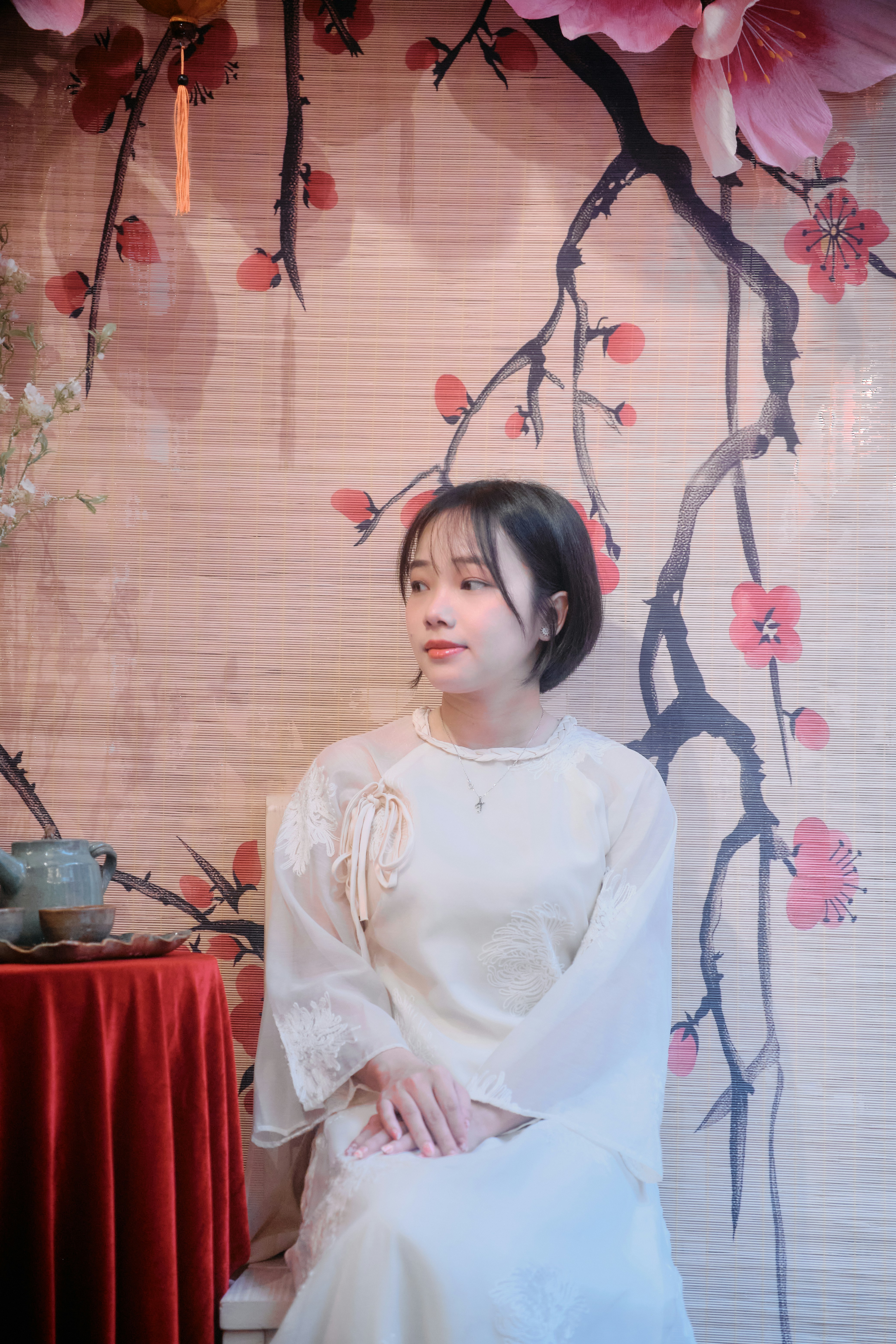 Young woman in traditional dress against floral background