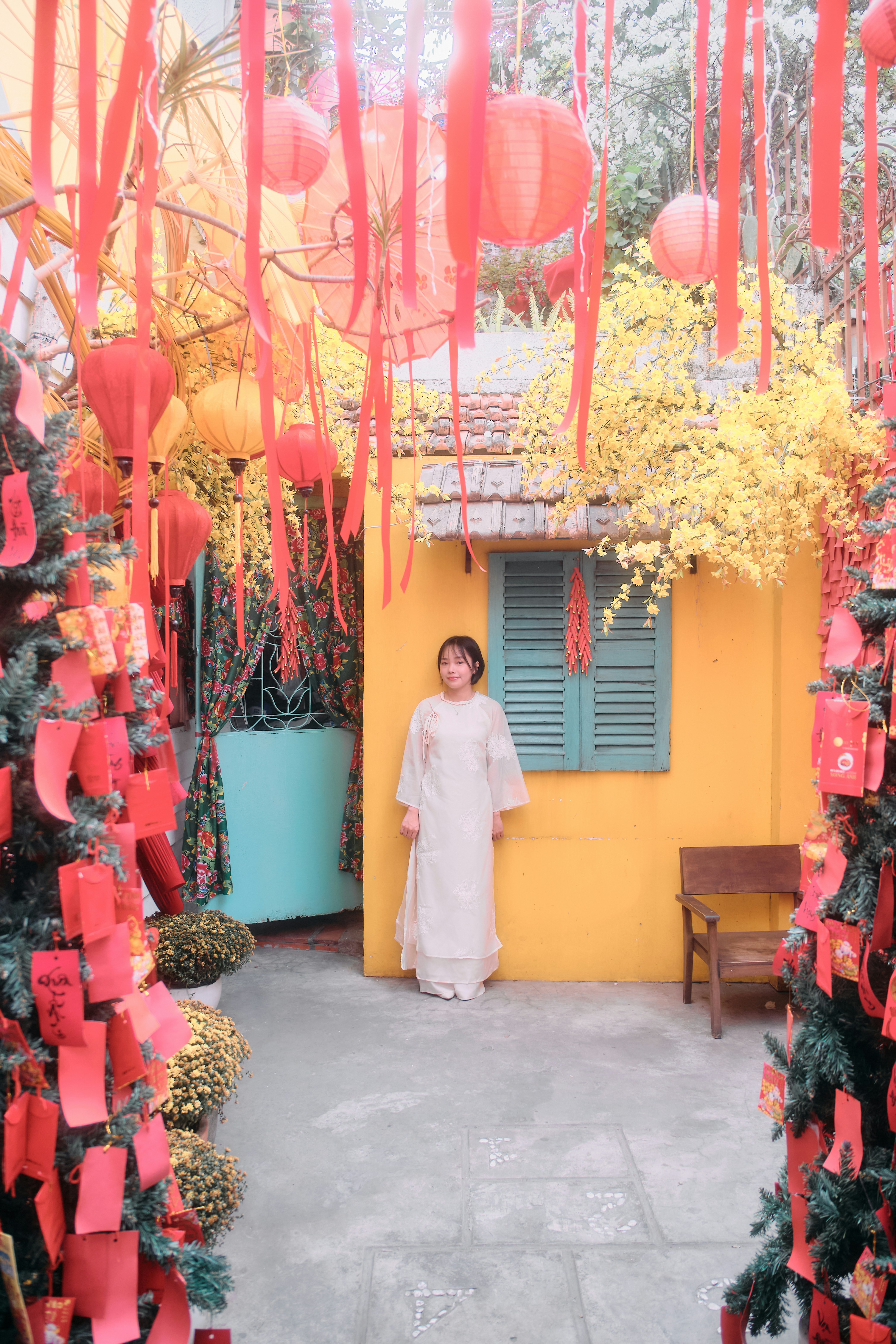 Woman in traditional dress amidst festive decorations