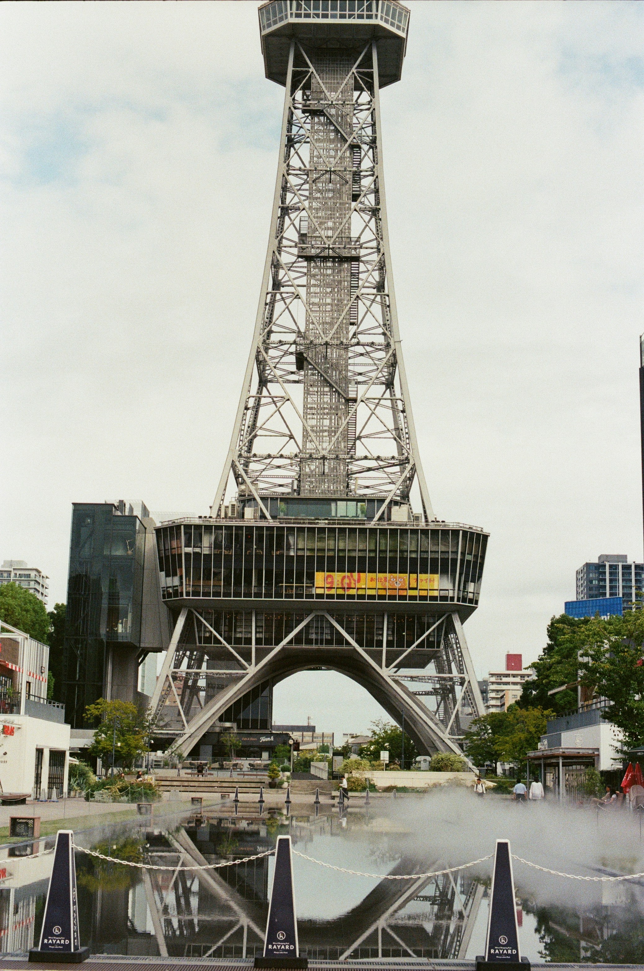 Tall metal tower with observation deck and reflection pool
