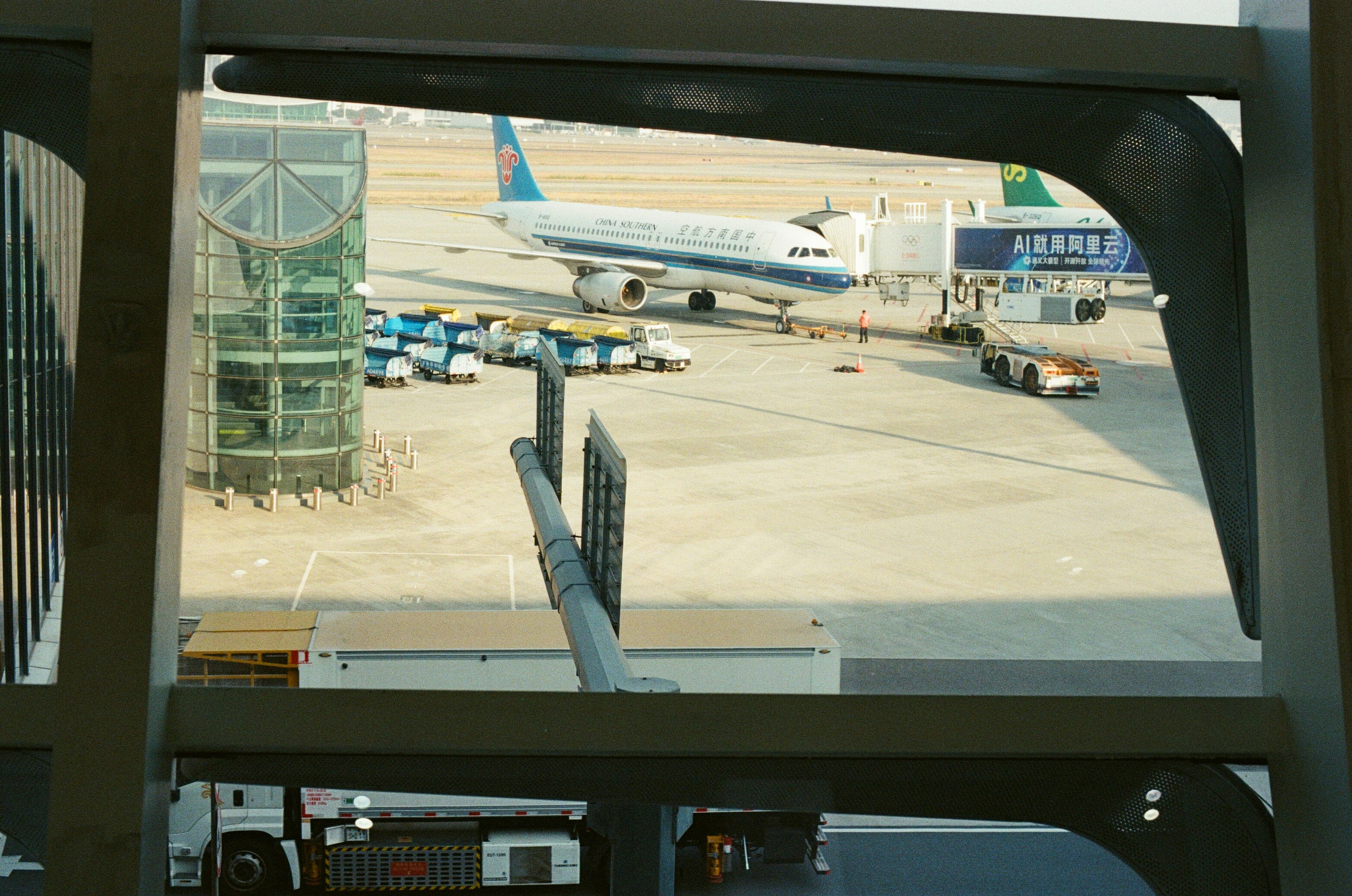 Airplane at airport gate with jet bridge attached.