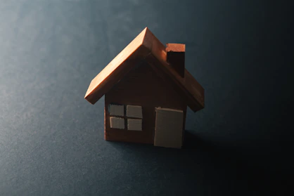 A small wooden house with windows and a door.