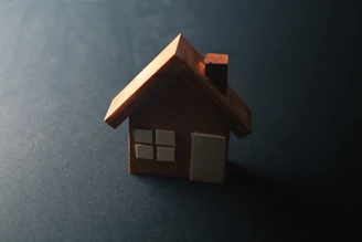 A small wooden house with windows and a door.