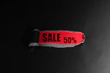 Red tag with "sale 50%" text on black background