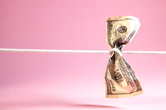 Dollar bill tied in a knot on a string